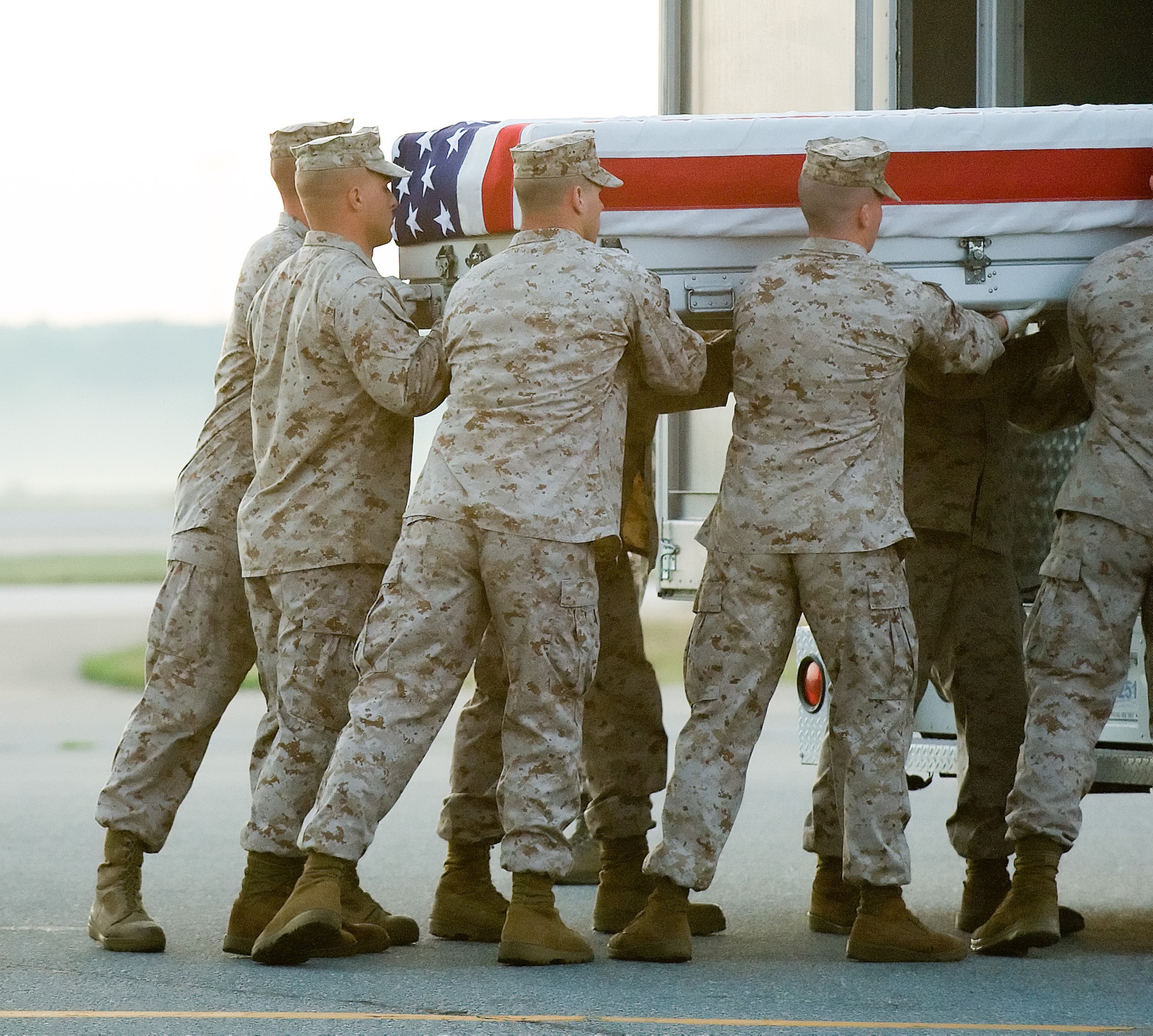 25 June 2010  USAF Photo by Jason Minto.  A U.S. Marine Corps carry team transfers the remains of Marine Cpl Claudio Patino IV of Yorba Linda, CA., at Dover Air Force Base, Del., June 25, 2010.  