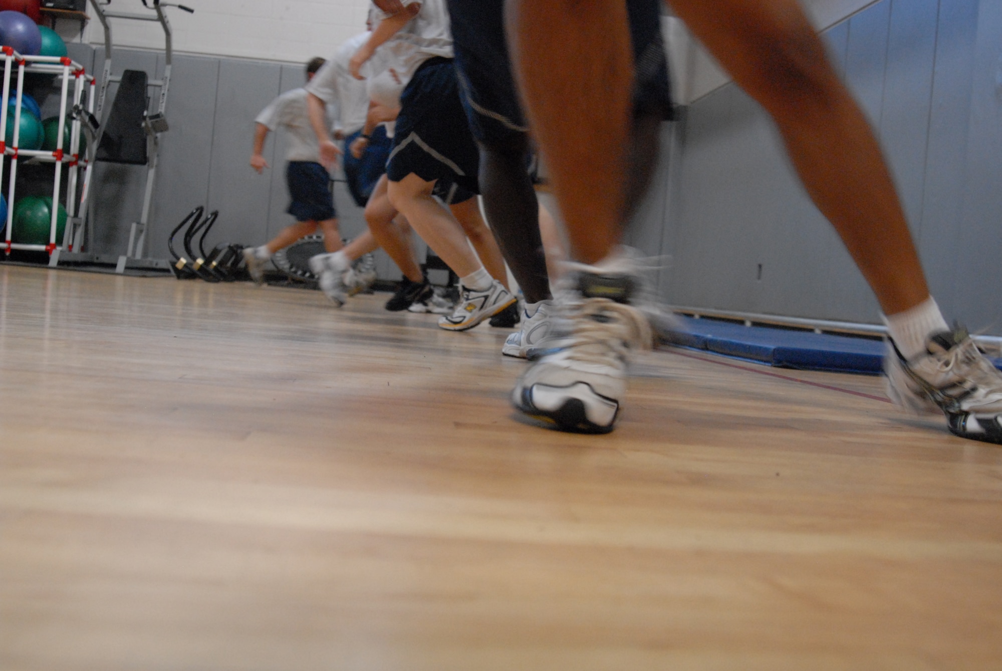 Members of the 1st Special Operations Wing Public Affairs office and Boot Camp participants, sprint across the multi-purpose room during a Boot Camp class at the Aderholt Fitness Center, Hurlburt Field, Fla., June 24, 2010.The Hurlburt Field Boot Camp, run by the base’s Health and Wellness Center, is a base-unique program that takes Airmen with marginal or failing scores through 80 days of intense physical training. (DoD photo by U.S. Air Force Staff Sgt. Orly N. Tyrell/Released)