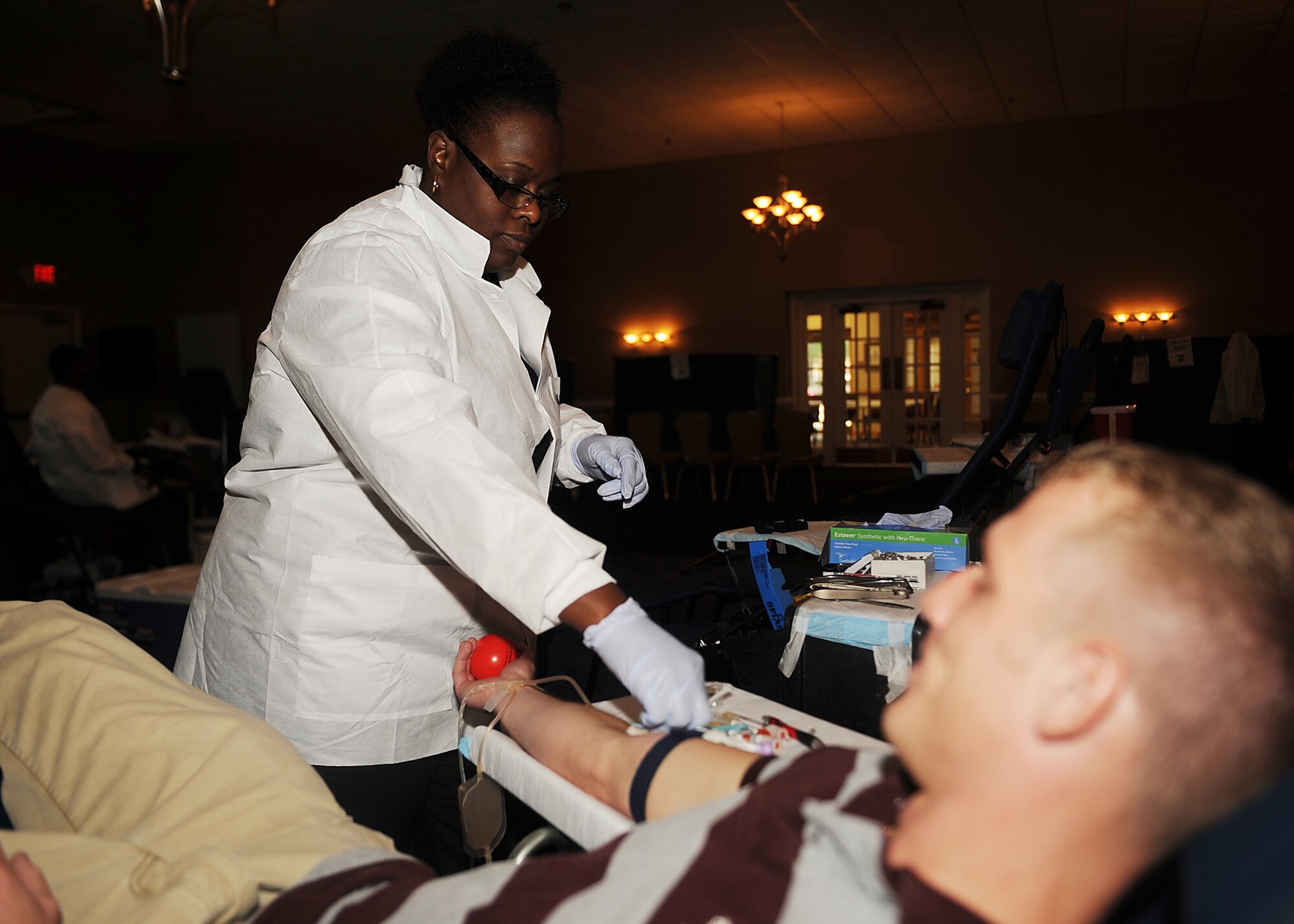 SEYMOUR JOHNSON AIR FORCE BASE, N.C. -- Teresa Thompson prepares Staff Sgt. Brandon Wagoner for blood donation during an Armed Service blood drive at Heritage Hall Community Center June 28, 2010. The ASBP has many facilities working together to collect, process, store, distribute and transfuse blood worldwide. Ms. Thompson, a Fort Bragg Blood Donor Center phlebotomist, hails from Bronx, N.Y. Sergeant Wagoner, 4th Security Forces Squadron investigator, hails from Honolulu. (U.S. Air Force photo/Senior Airman Ciara Wymbs)
