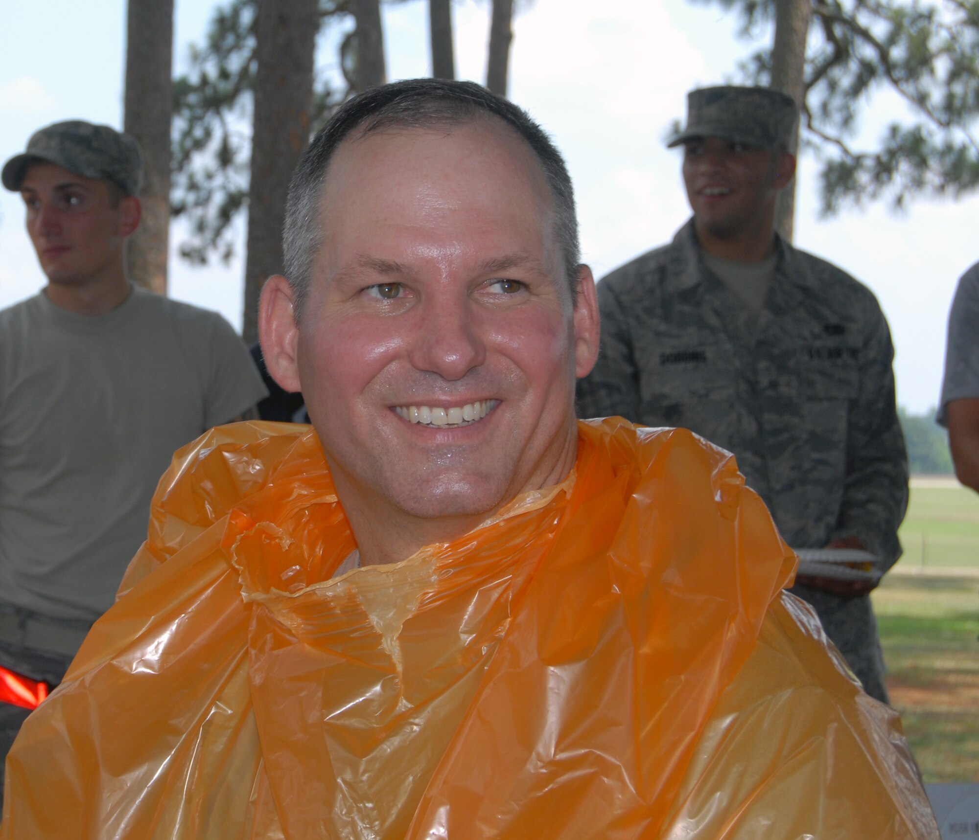 Chief Master Sgt. Patton Scales, 3rd Aerial Port Squadron superintendent, prepares to have his head shaved during a squadron picnic June 25 at Woodland Park, here. Chief Scales, Lt. Col. Frank Flores, 3rd APS commander, and Edwin Byrnes, 3rd APS assistant director of operations, agreed to shave their heads provided the squadron scored an "outstanding” in a recent inspection. (U.S. Photo/ 1st Lt. Cammie Quinn)