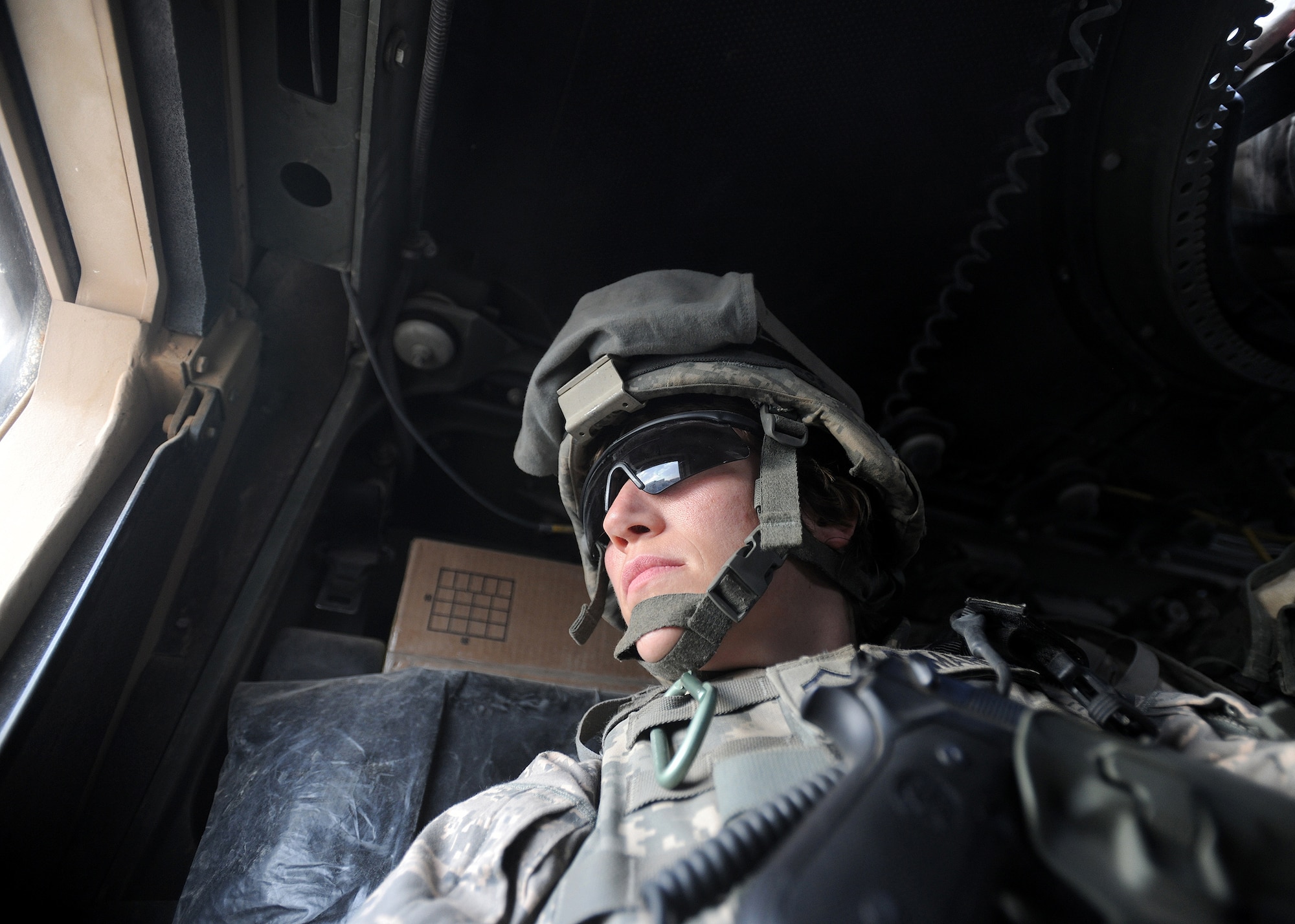 After completing a quality assessment quality check mission in the nearby village of Kadanak, Master Sgt. Tracy DeMarco, Farah Provincial Reconstruction Team photojournalist, returns with the convoy to Forward Operating Base Farah, Afghanistan, Nov. 4, 2009. “I could exhale when we returned to our FOB and every vehicle pulled through the gate. Every day we made it back safe with no one injured was a good day,” said Sergeant DeMarco.