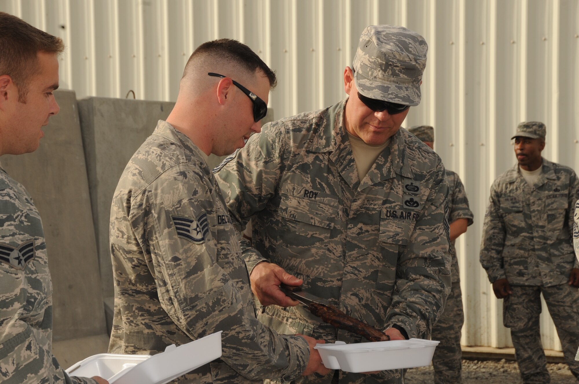 Chief Master Sgt. of the Air Force James A. Roy serves stake to Staff. Sgt. William Del Castillo and more than 50 Airmen June 27 at an undisclosed base in Southwest Asia. Chief Roy was here as part of as part of his tour of bases in the U.S. Central Command area of responsibility. (U.S. Air Force photo/ Tech. Sgt. April Wickes)