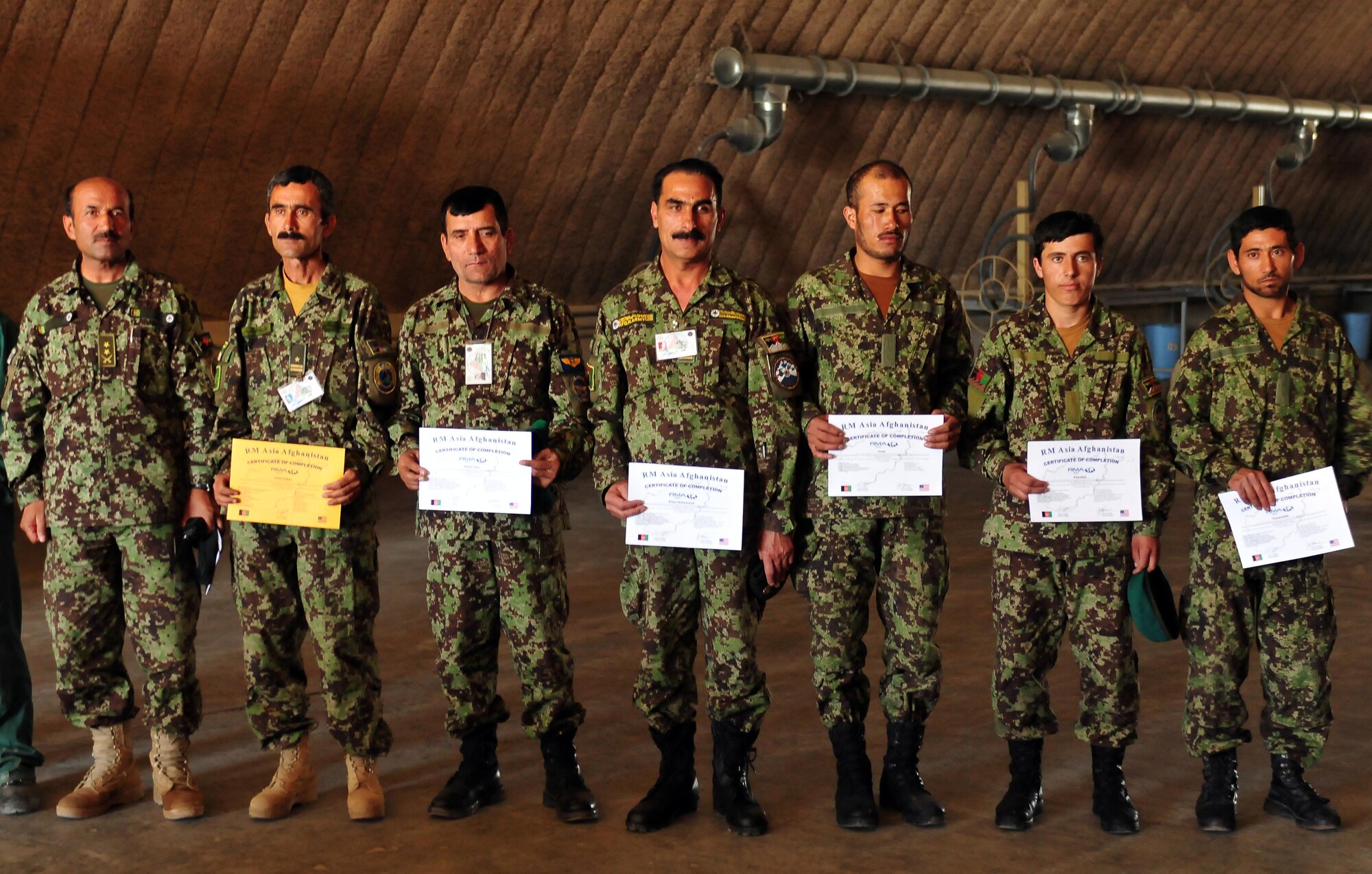 100628-N-6031Q-003 KABUL, Afghanistan --  Seven Afghan soldiers from the basic mechanics course hold there graduation certificates after their ceremony at the Afghan National Army Air Force base in Kabul, Afghanistan. The graduation was held on June 28, 2010 and was attended by American Air Force mentors and Afghan leadership. (US Navy photo by Mass Communication Specialist 2nd Class David Quillen/ RELEASED).