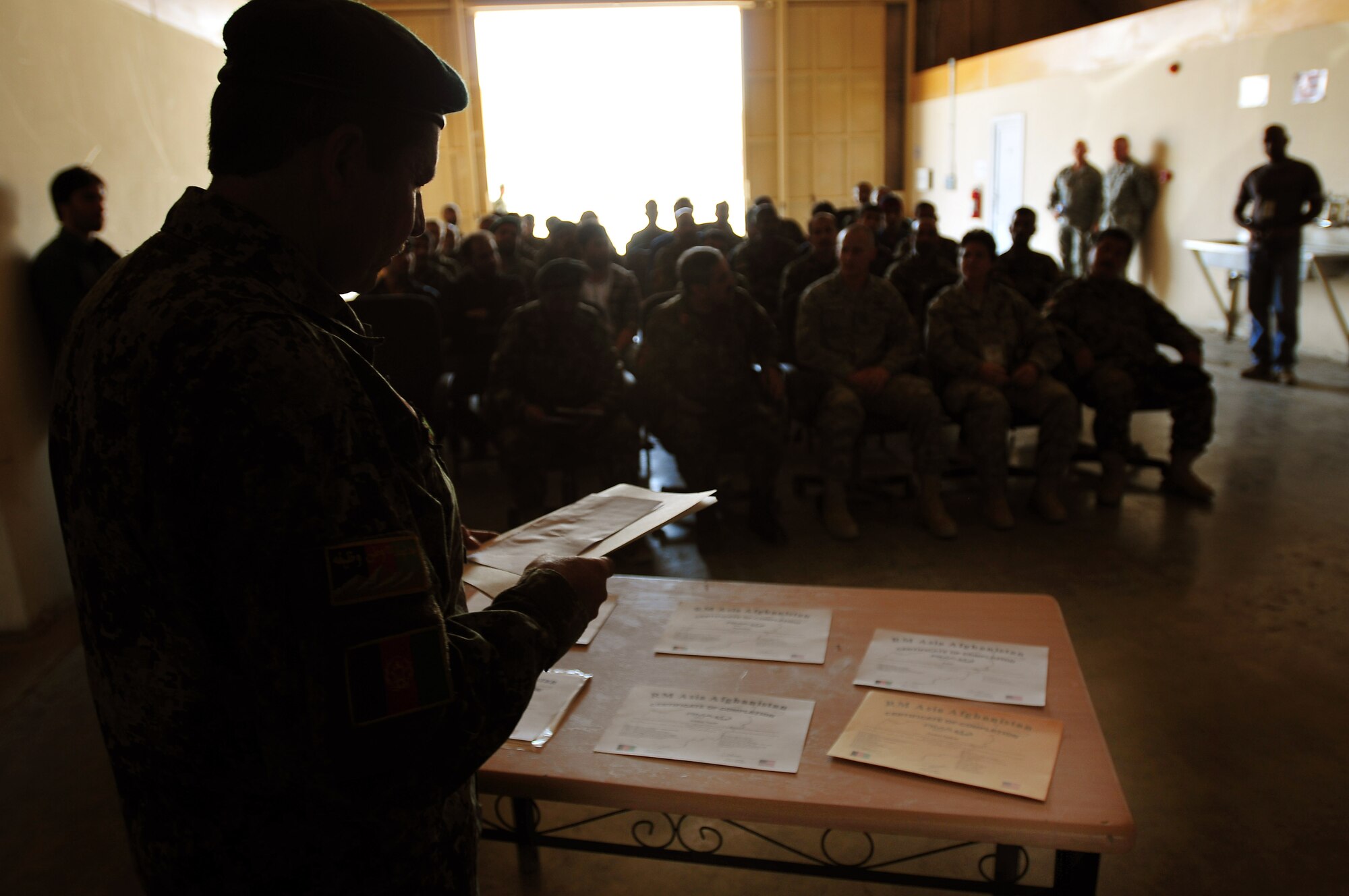 100628-N-6031Q-001 KABUL, Afghanistan -- Certificates of completion await a top table prior to the graduation of seven Afghan soldiers from the basic mechanics course held at the Afghan National Army Air Force base in Kabul, Afghanistan. The graduation was held on June 28, 2010 and was attended by American Air Force mentors and Afghan leadership. (US Navy photo by Mass Communication Specialist 2nd Class David Quillen/ RELEASED).