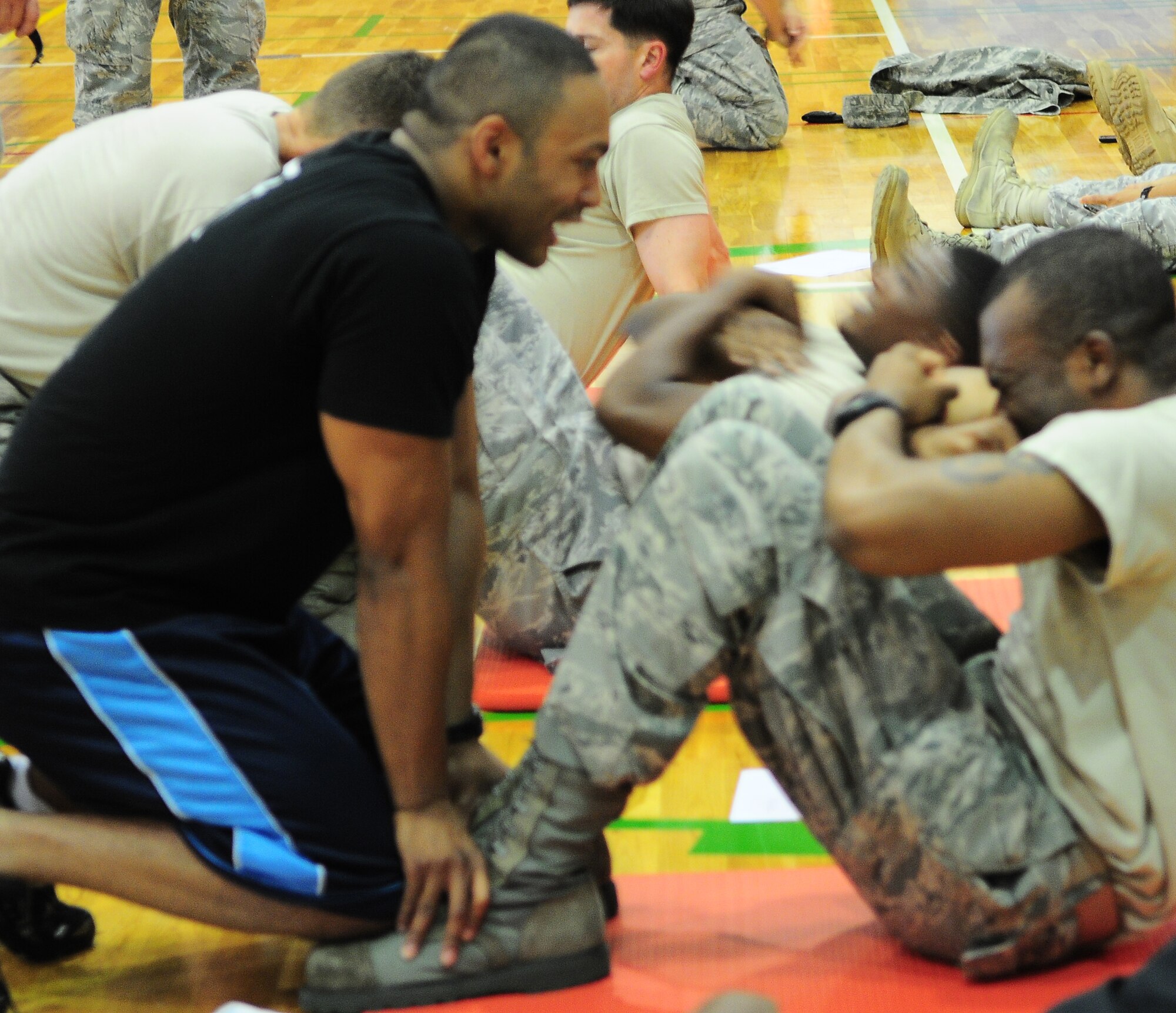 YOKOTA AIR BASE, Japan -- Airmen from Team Yokota participate in a push-up/ sit-up fundraiser hosted by the Chief's Group at the Samurai Fitness Center here, June 25. Funds raised from the event were donated to the Enlisted Village and the Chief's Group to improve the quality of living for Airmen. (U.S. Air Force photo/Airman 1st Class Lynsie Lorenz)