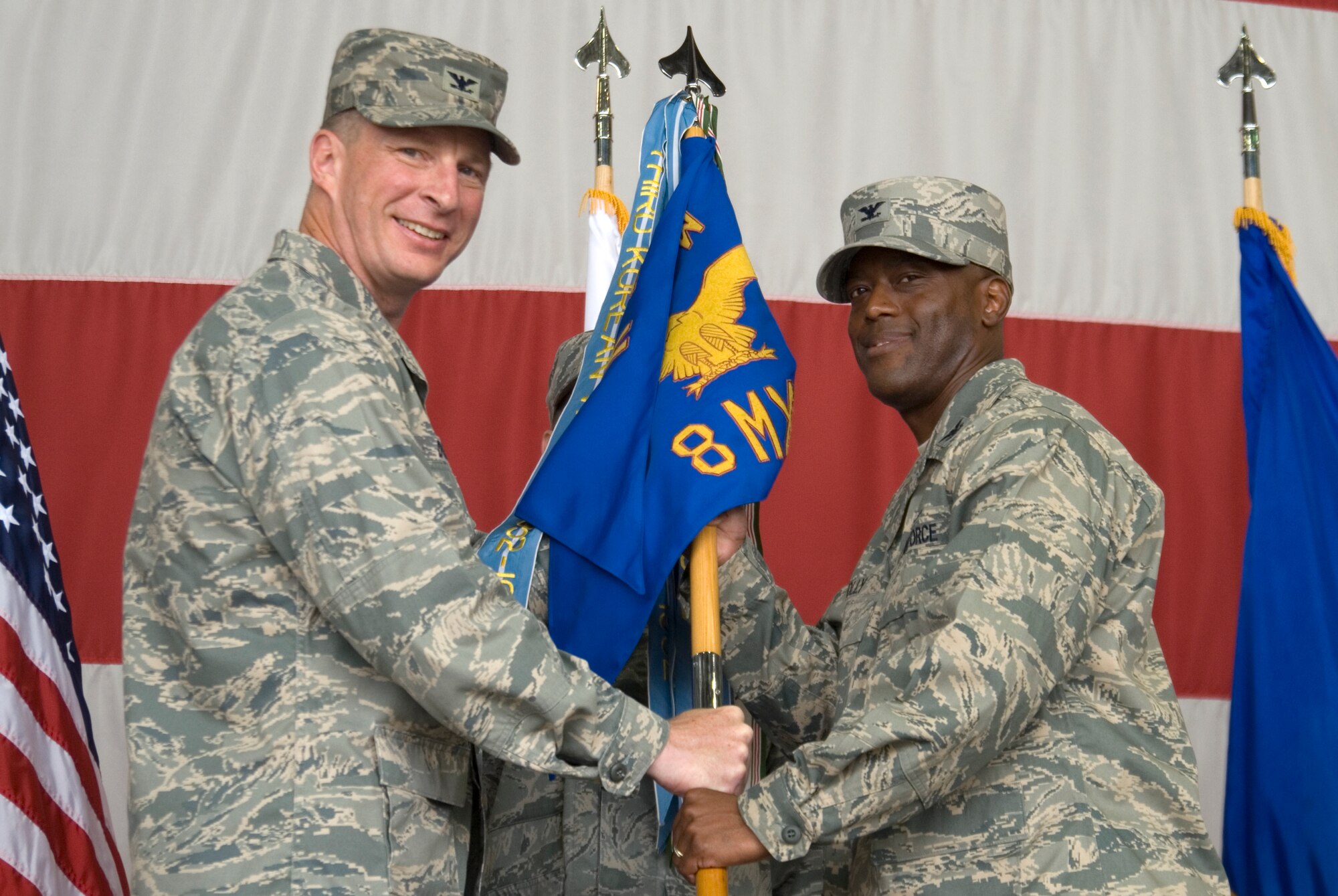 KUNSAN AIR BASE, Republic of Korea --  Col. John Dolan, 8th Fighter Wing commander, presents the guidion to Col. Ronald Jolly Sr. during the 8th Maintenance Group Change of Command ceremony June 29. Colonel Jolly is replacing the former commander Col. Randy Mauldin. (U.S. Air Force photo/Staff Sgt. Jonathan Pomeroy)