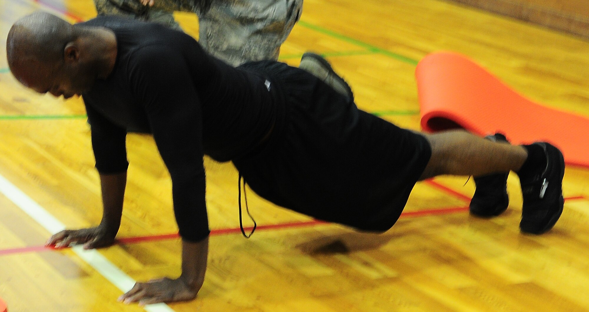 YOKOTA AIR BASE, Japan -- Tech. Sgt. Duan McMillan, 374th Force Support Squadron fitness assessment tester, makes sure he has proper form during the push-up/ sit-up fundraiser the Chief's Group hosted at the Samurai Fitness Center here, June 25. The fundraiser was held to raise money for the Enlisted Village and the Chief's Group as a way to improve the quality of living for Airmen. (U.S. Air Force photo/Airman 1st Class Lynsie Lorenz)