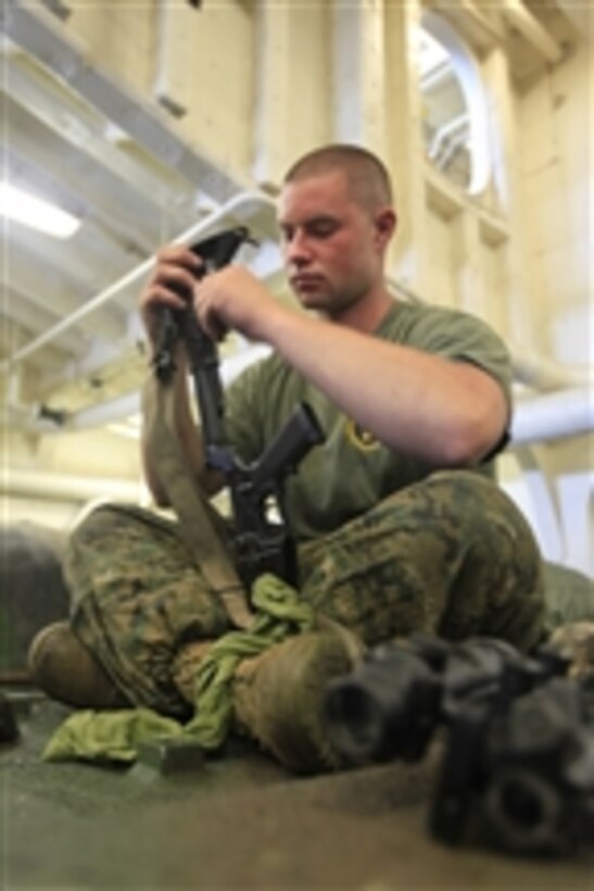 U.S. Marine Corps Cpl. Paul J. Blaho, with 4th Platoon, Charlie Company, 3rd Assault Amphibian Battalion, 1st Marine Division, cleans his M-4 carbine in the well deck of the amphibious transport dock ship USS New Orleans (LPD 18) in the Pacific Ocean on June 24, 2010.  The unit was embarked on the New Orleans in support of operation Partnership of the Americas/Southern Exchange, a combined amphibious exercise designed to enhance cooperative partnerships with maritime forces from Argentina, Mexico, Peru, Brazil, Uruguay and Colombia.  