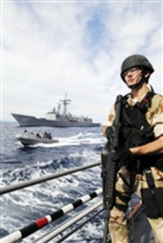 U.S. Navy Ensign Bryan Kline, assigned to the frigate USS Taylor (FFG 50), stands ready aboard the Croatian coast guard vessel Hrvatska Kostajnica (OB 64) as a rigid-hulled inflatable boat approaches while underway in the Adriatic Sea participating in the maritime exercise Partnership of Adriatic Mariners on June 23, 2010.  