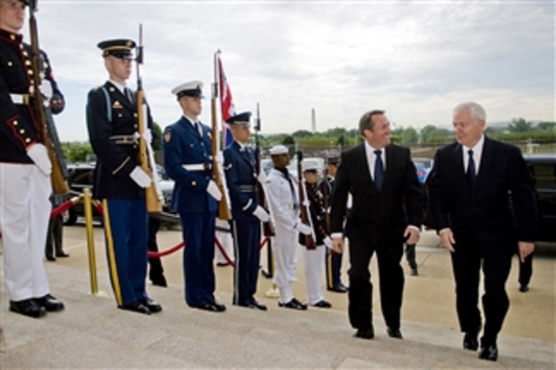 Secretary of Defense Robert M. Gates (right) escorts British Secretary of State for Defense Liam Fox through an honor cordon and into the Pentagon on June 29, 2010.  