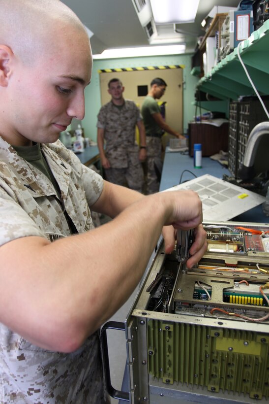 Lance Cpl. Brent Knickerbocker, an air traffic control radar maintenance specialist, disassembles a piece of radar equipment at Marine Air Control Squadron 4 Detachment B here June 29.