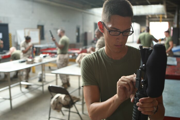 Marines with Headquarters and Support Battalion, Marine Corps Base Camp Lejeune, clean their weapons at the armory after firing on the rifle range, recently.