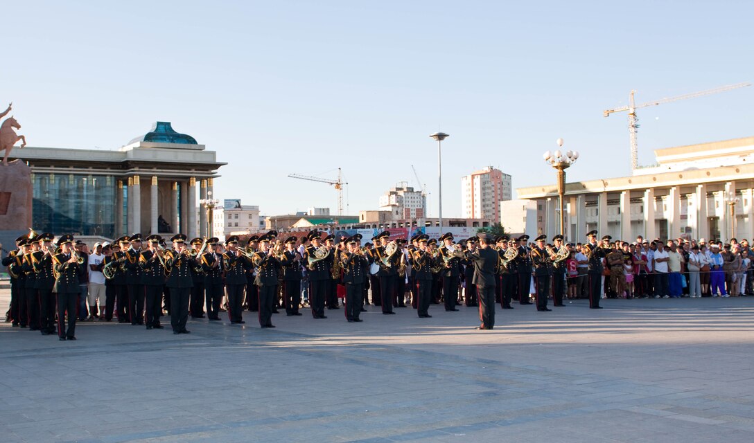 The Central Orchestra of the General Staff of the Mongolian Armed Forces (MAF Band), conducted by MAF Capt. E. Gansukh, performs traditional music during their part of a joint concert with the U.S. Marine Corps Forces, Pacific Band in Sukhbaatar Square, Ulaanbaatar, Mongolia, June 30. This is the fourth year the MarForPac Band traveled to Mongolia to participate in a subject matter expert exchange with their Mongolian counterparts.