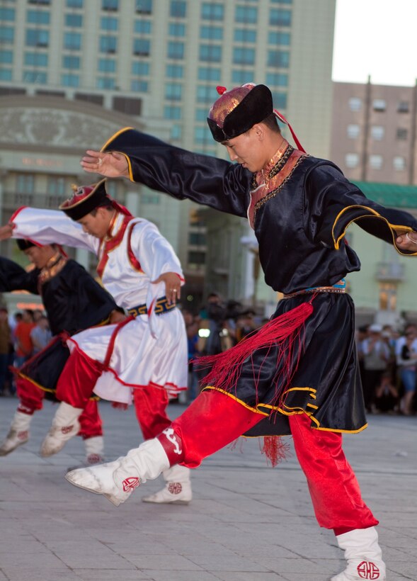 Traditional Mongolian dancers perform to the sounds of the Central Orchestra of the General Staff of the Mongolian Armed Forces (MAF Band)  as they perform before a crowd of more than 300 people in Sukhbaatar Square, Ulaanbaatar, Mongolia, June 30. The MAF Band teamed up with the U.S. Marine Corps Forces, Pacific Band to hold the free, public concert.