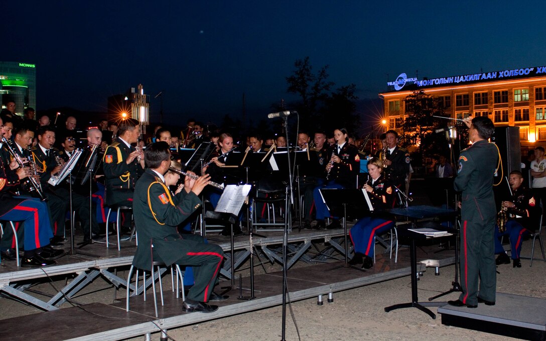 Mongolian Armed Forces Lt. Col. Tumurbat Tsedensodnom leads the U.S. Marine Corps Forces, Pacific Band and the Central Orchestra of the General Staff of the Mongolian Armed Forces (MAF Band) as they perform together during a free, public concert at Sukhbaatar Square, Ulaanbaatar, Mongolia, June 30. After several brief rehearsals, the MarForPac and MAF Bands held several free, public concerts.
