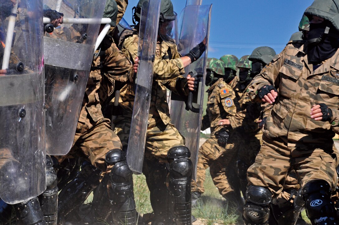 One platoon of Mongolian Armed Force Members simulates a rioting crowd while another platoon practices riot-control formation on June 30 during an exercise in non-lethal weapons and tactics for a demonstration part of Non-Lethal Weapons Executive Seminar 2010 held in Mongolia. The seminar is an annual event held in a different country in the Asia-Pacific region each year.
