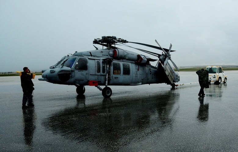 ANDERSEN AIR FORCE BASE, Guam ? Air Force personnel work with Airmen from the Helicopter Sea Combat Squadron 25 to unload two MH-60S Knighthawk from a C-17 Globemaster here June 23, 2010. The aircraft arrived as part of the HSC -25 air asset rotation. The massive undertaking of unloading the two aircraft showcased the team work that is central to Joint Region Marianas.