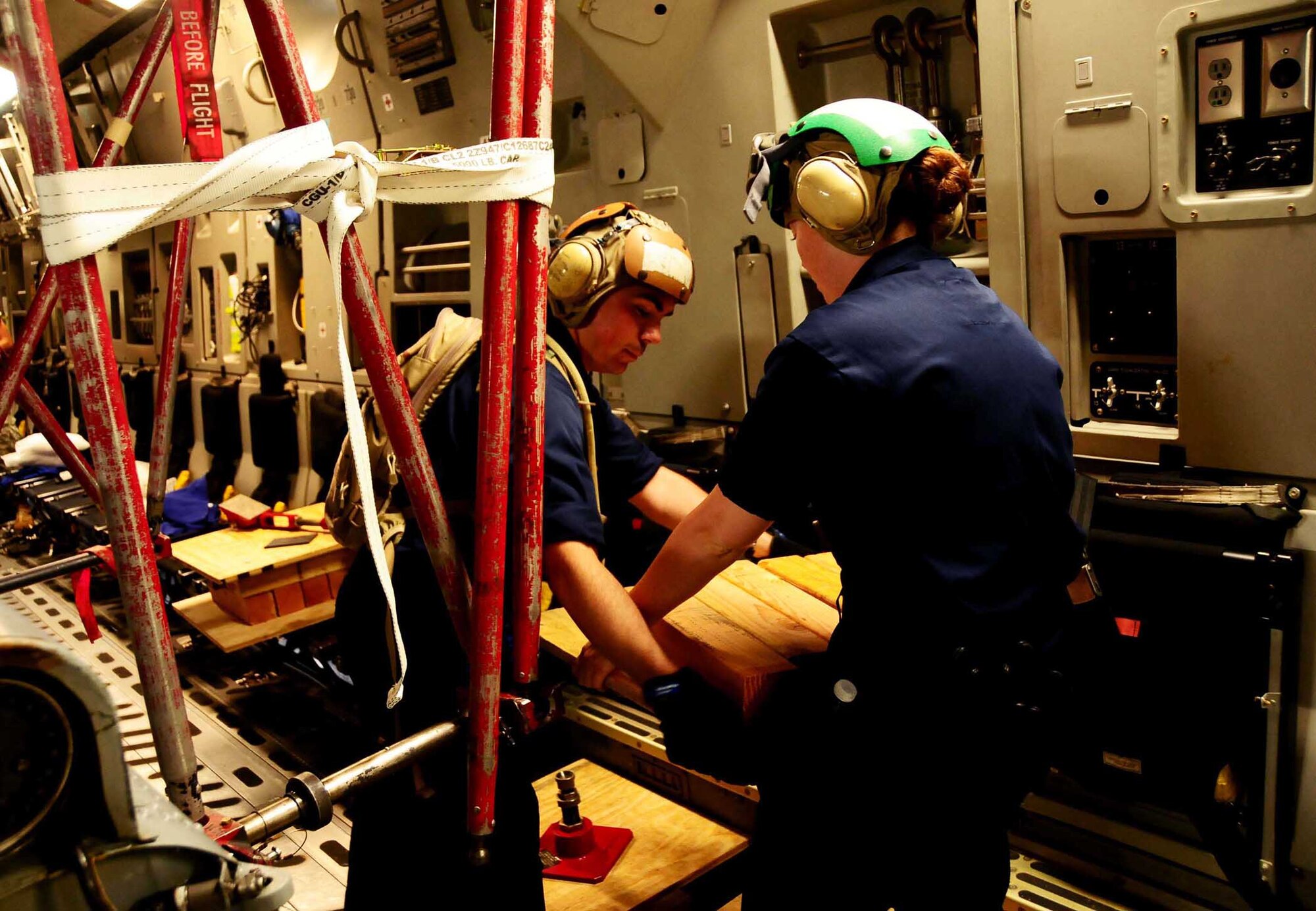 ANDERSEN AIR FORCE BASE, Guam ? Air Force personnel work with Airmen from the Helicopter Sea Combat Squadron 25 to unload two MH-60S Knighthawk from a C-17 Globemaster here June 23, 2010. The aircraft arrived as part of the HSC -25 air asset rotation. The massive undertaking of unloading the two aircraft showcased the team work that is central to Joint Region Marianas.