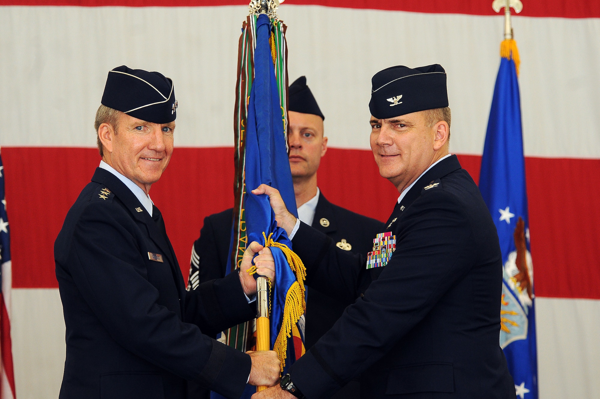 ANDERSEN AIR FORCE BASE, Guam - Brig. Gen. (select) John Doucette assumes command of the 36th Wing from Lt. Gen. Hawk Carlisle, Commander 13th Air Force, here June 25. Brig. Gen. (select) Doucette was commissioned at Officer Training School in 1986 and is a command pilot with over 2,600 hours of flight time. (U.S. Air Force photo by Airman Julian North)