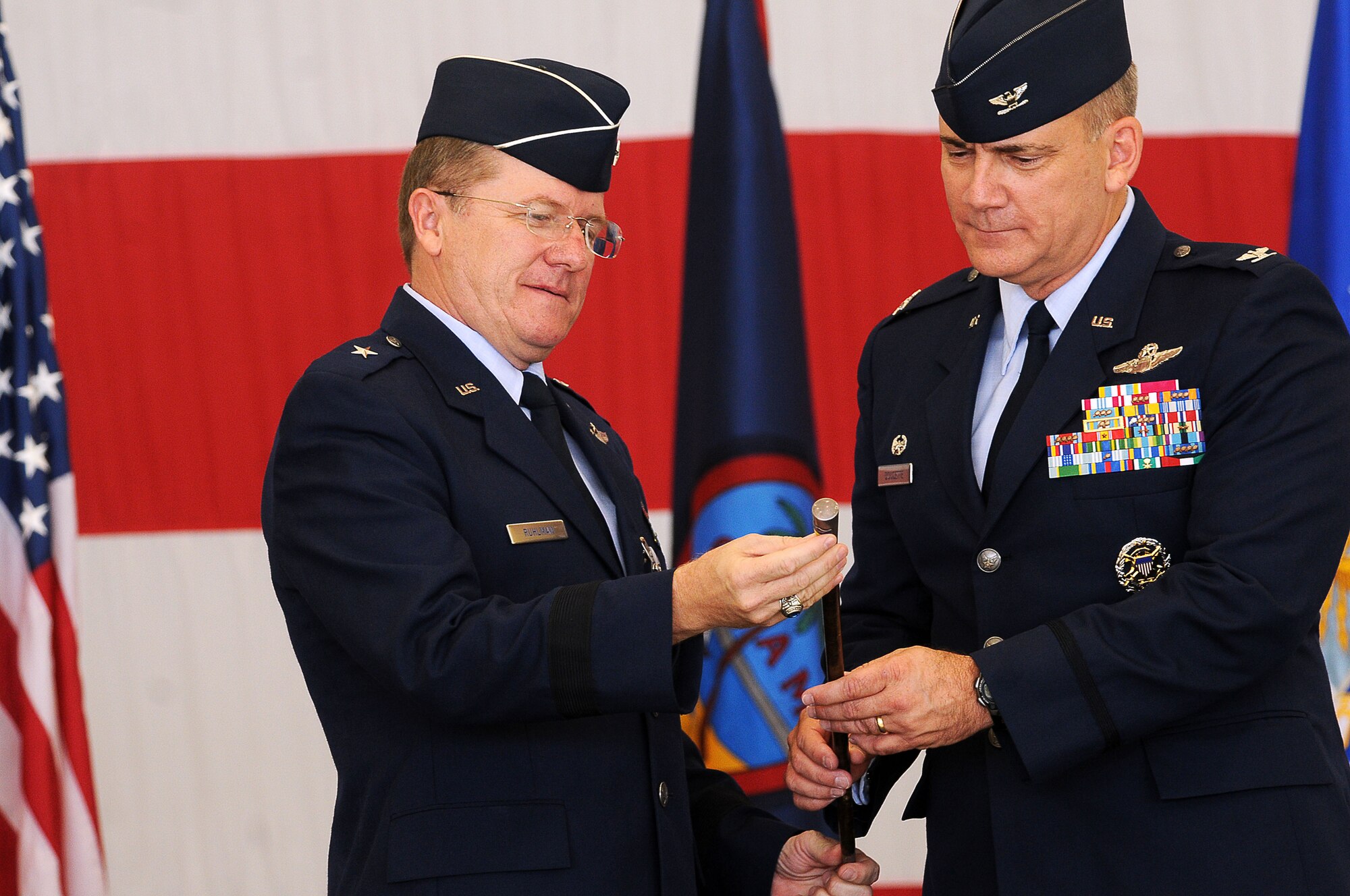 ANDERSEN AIR FORCE BASE, Guam - Brig. Gen. Philip Ruhlman, former Commander of the 36th Wing, passes on the ceremonious Swagger Stick to Brig. Gen. (select) John Doucette, the new 36th Wing Commander, during the 36th Wing Change of Command Ceremony here June 25. The Swagger Stick was originally presented to the 36th Tactical Fighter Wing by Maj. Gen. Charles Bondley (ret.) and has been passed on to every incoming wing commander since. (U.S. Air Force photo by Airman Julian North)