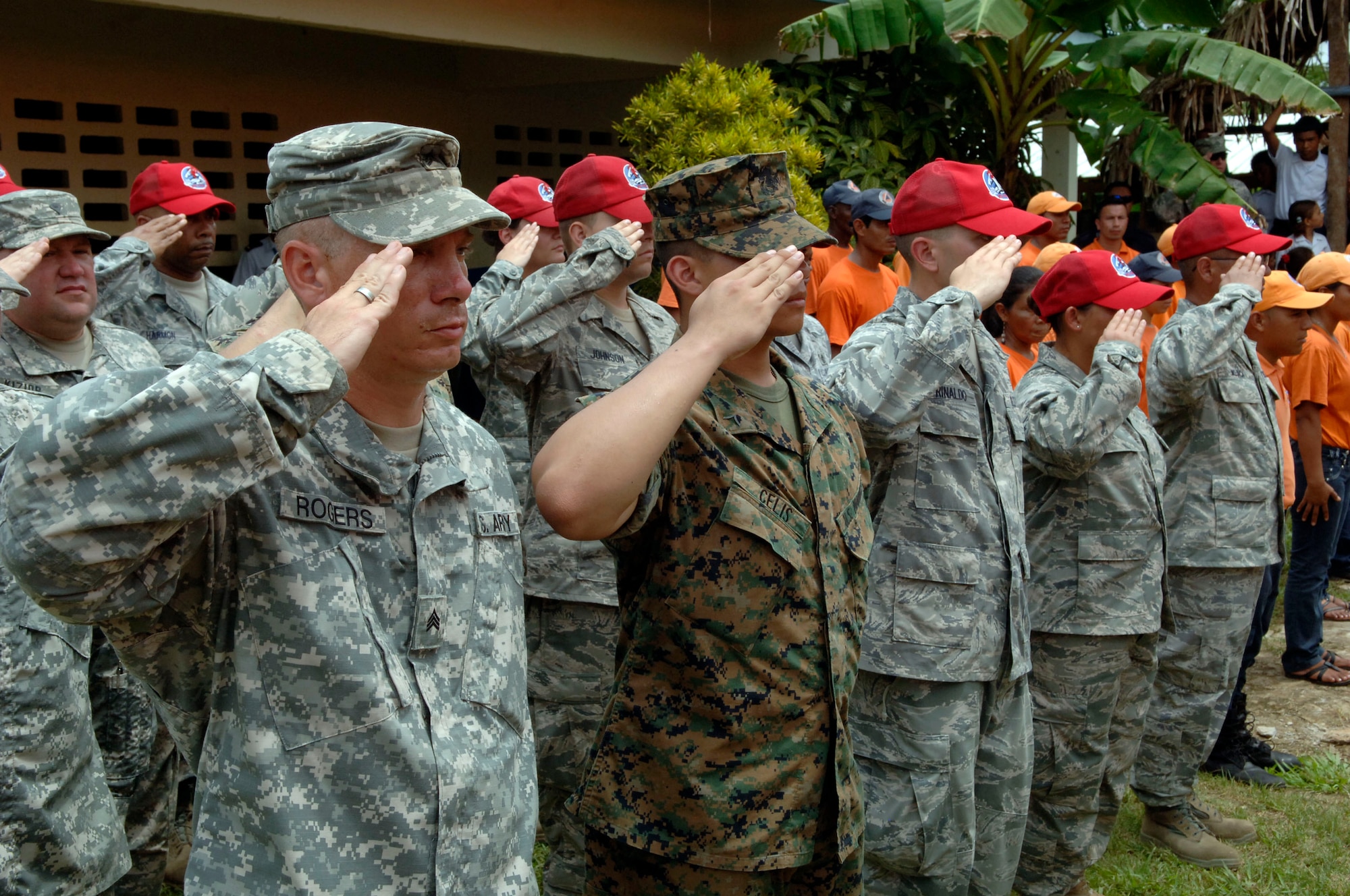 A multi-service formation renders salutes for the U.S. and Panamanian national anthems during the New Horizons Panama 2010 opening ceremony June 29 at Santa Librada Elementary School. (U.S. Air Force photo/Tech. Sgt Eric Petosky)