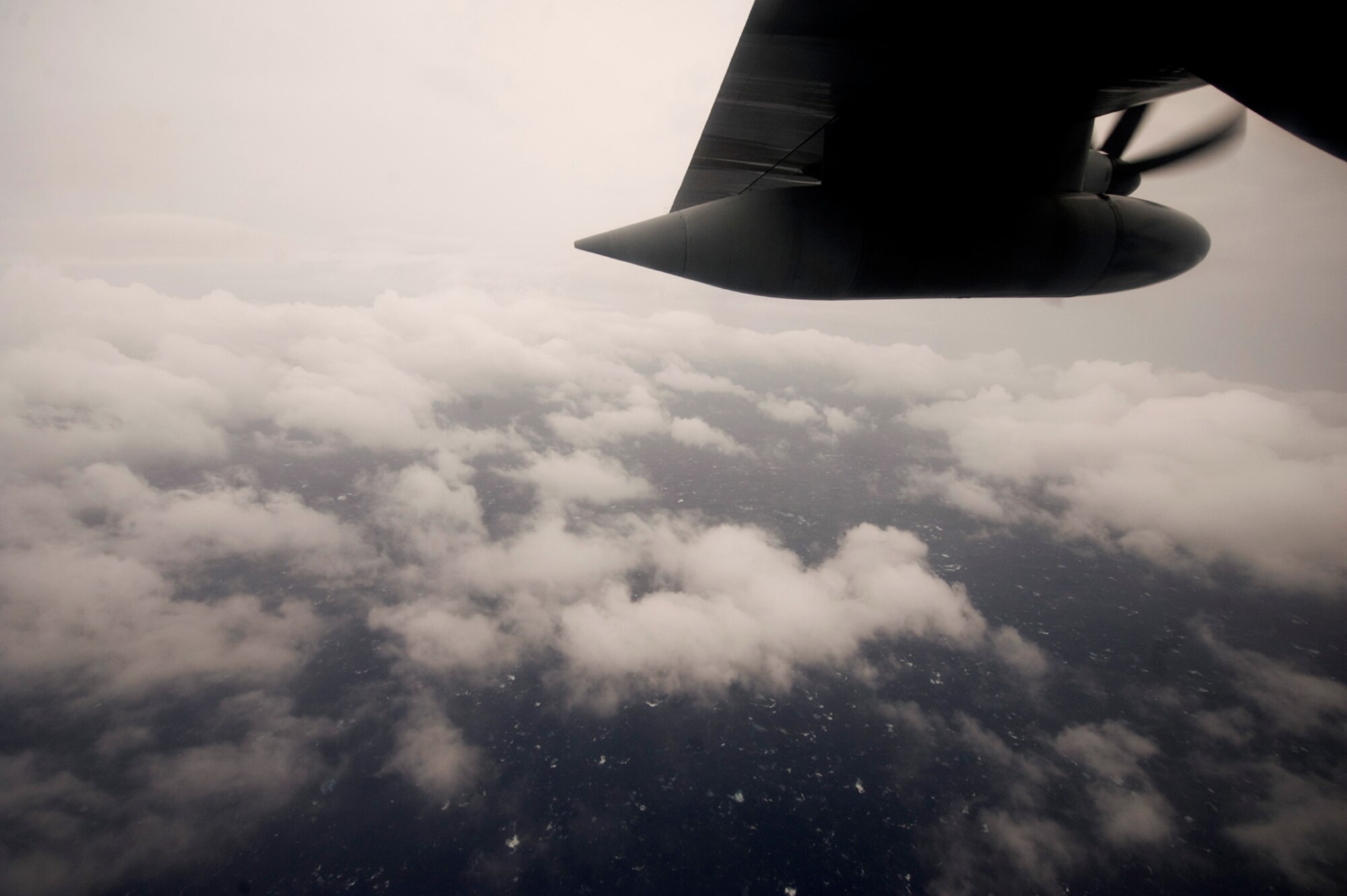 As day breaks over the Gulf of Mexico June 29, 2010, an opening in the clouds of Hurricane Alex allows the Hurricane Hunter aircrew aboard a WC-130J Hercules a brief glimpse of the water surface.  (U.S. Air Force photo/Master Sgt. Jack Braden)
