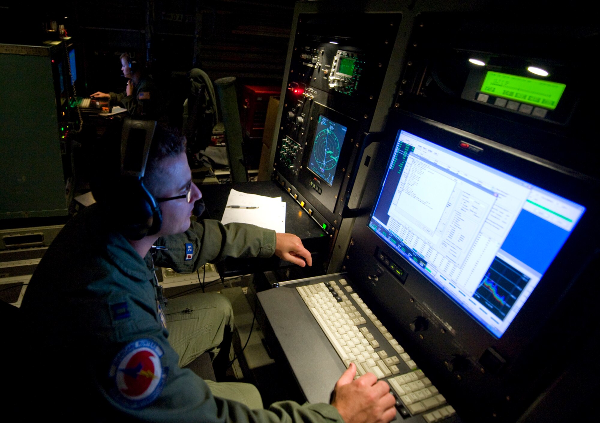 On board a WC-130J Hercules aircraft, Hurricane Hunters Capt. Douglas Gautrau, foreground, an air reconnaissance weather officer, and Senior Airman Jenna Daniel, a weather reconnaissance loadmaster, collect weather information about Hurricane Alex June 29, 2010.  Both are assigned to the 53rd Weather Reconnaissance Squadron at Keesler Air Force Base, Miss.  (U.S. Air Force photo/Master Sgt. Jack Braden)