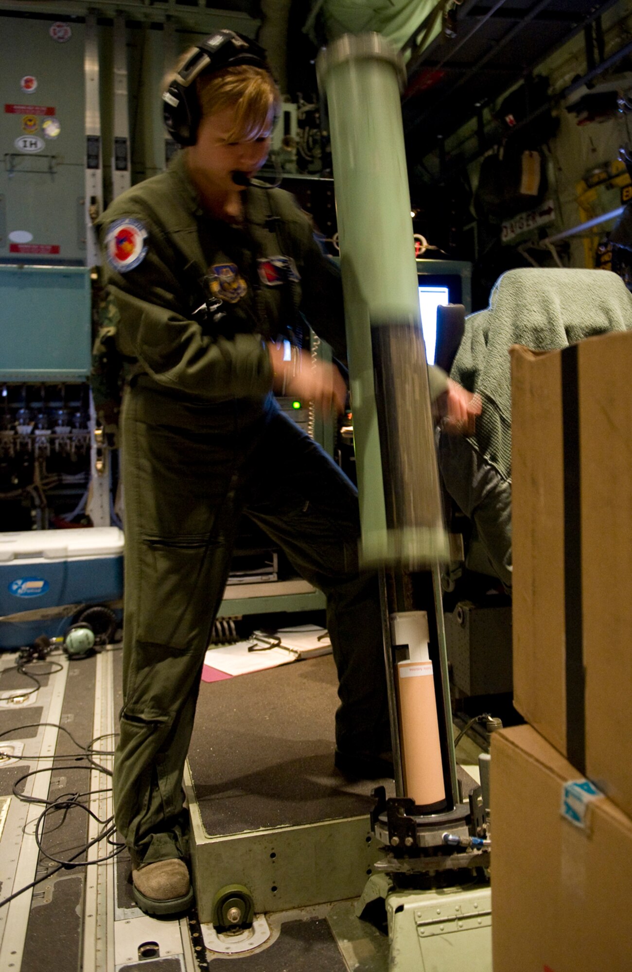Aboard a WC-130J Hercules aircraft, Senior Airman Jenna Daniel loads a dropsonde for release into Hurricane Alex June 29, 2010. Weather information transmitted by the sonde is collected and evaluated to gain information about how the storm is changing.  Airman Daniel is a weather reconnaissance loadmaster with the 53rd Weather Reconnaissance Squadron at Keesler Air Force Base, Miss.  (U.S. Air Force photo/Master Sgt. Jack Braden)