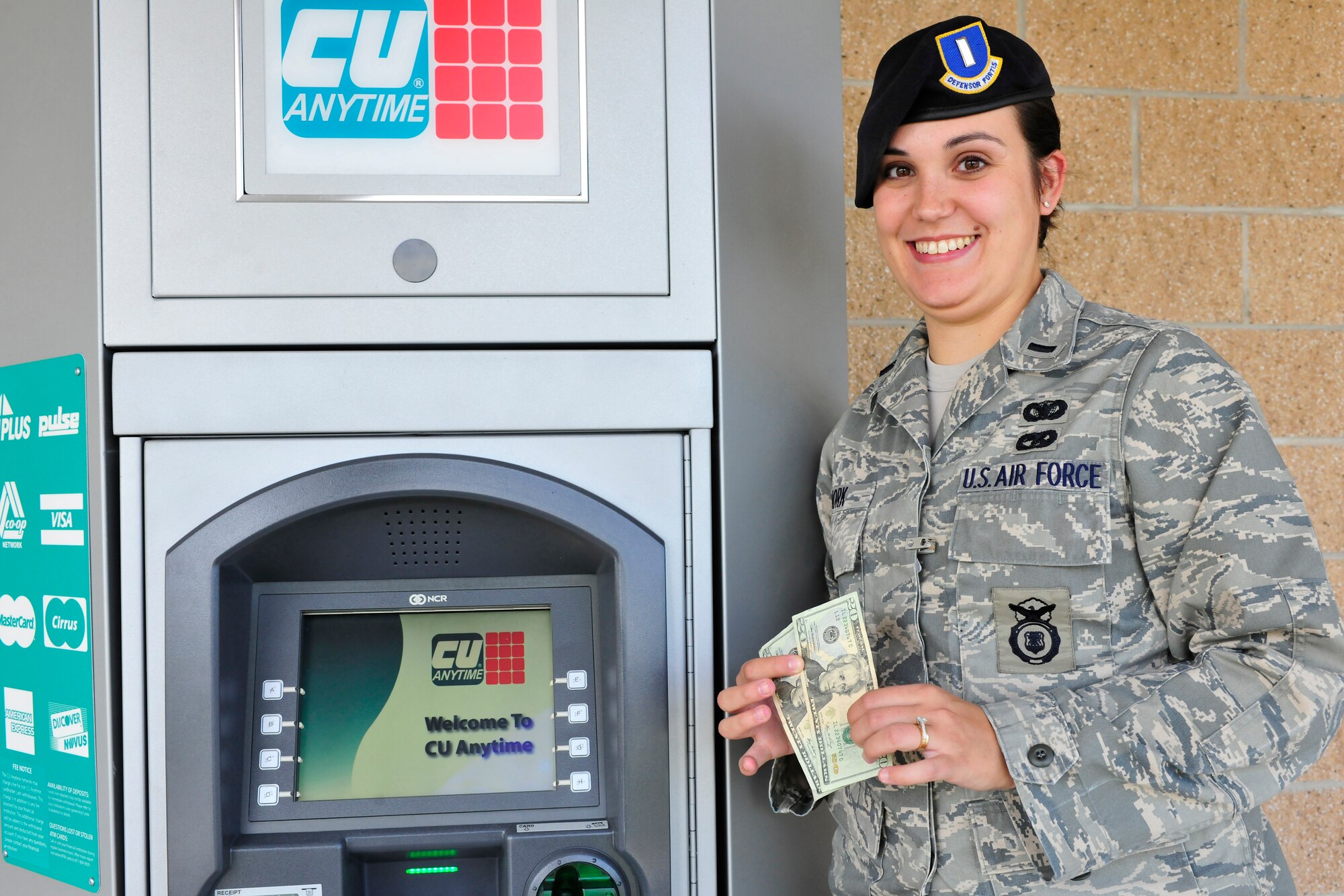 U.S. Air Force 1st Lt. Mary Work of the 27th Special Operations Security Forces Squadron and chairwoman of the Quality of Life Council draws money from an automatic teller machine at the Cannon Air Force Base dining facility, June 30, 2010. The ATM was a convenience requested by base personnel and secured by the Quality of Life Council. (U.S. Air Force photo by Tech. Sgt. Josef Cole)