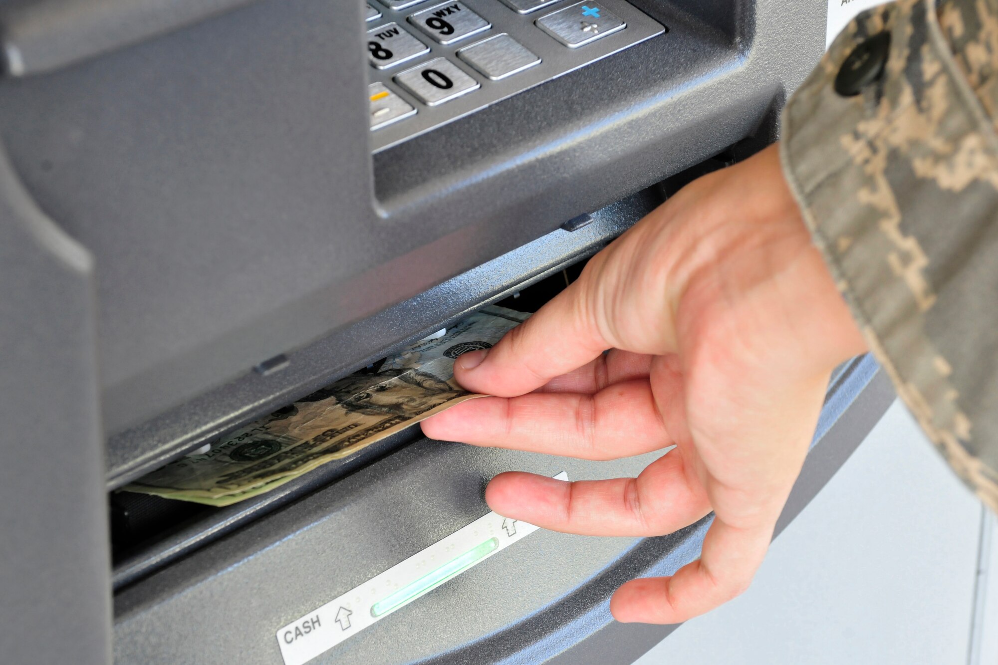 U.S. Air Force 1st Lt. Mary Work of the 27th Special Operations Security Forces Squadron and chairwoman of the Quality of Life Council draws money from an automatic teller machine at the Cannon Air Force Base dining facility, June 30, 2010. The ATM was a convenience requested by base personnel and secured by the Quality of Life Council. (U.S. Air Force photo by Tech. Sgt. Josef Cole)