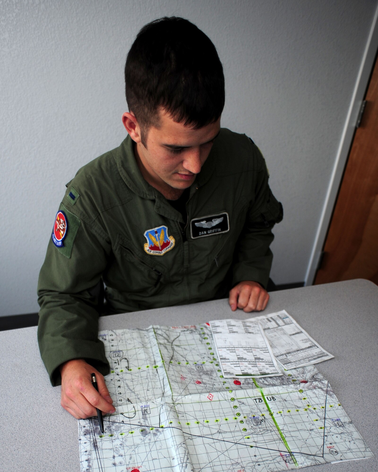 1st Lt. Dan Griffin, a pilot from the 358th Fighter Squadron, reviews the scenario for an upcoming surface attack tactics flight, here June 29. On the mission he’s preparing for he will fly out to the Barry M. Goldwater range and drop BDU 50’s, practice bombs which simulate the MK 82 general purpose bomb. Lieutenant Griffin is a student in the A-10C Pilot Initial Qualification course and upon completion of this course he will be a fully qualified A-10C Pilot. (U.S. Air Force photo/Airman 1st Class Jerilyn Quintanilla)
