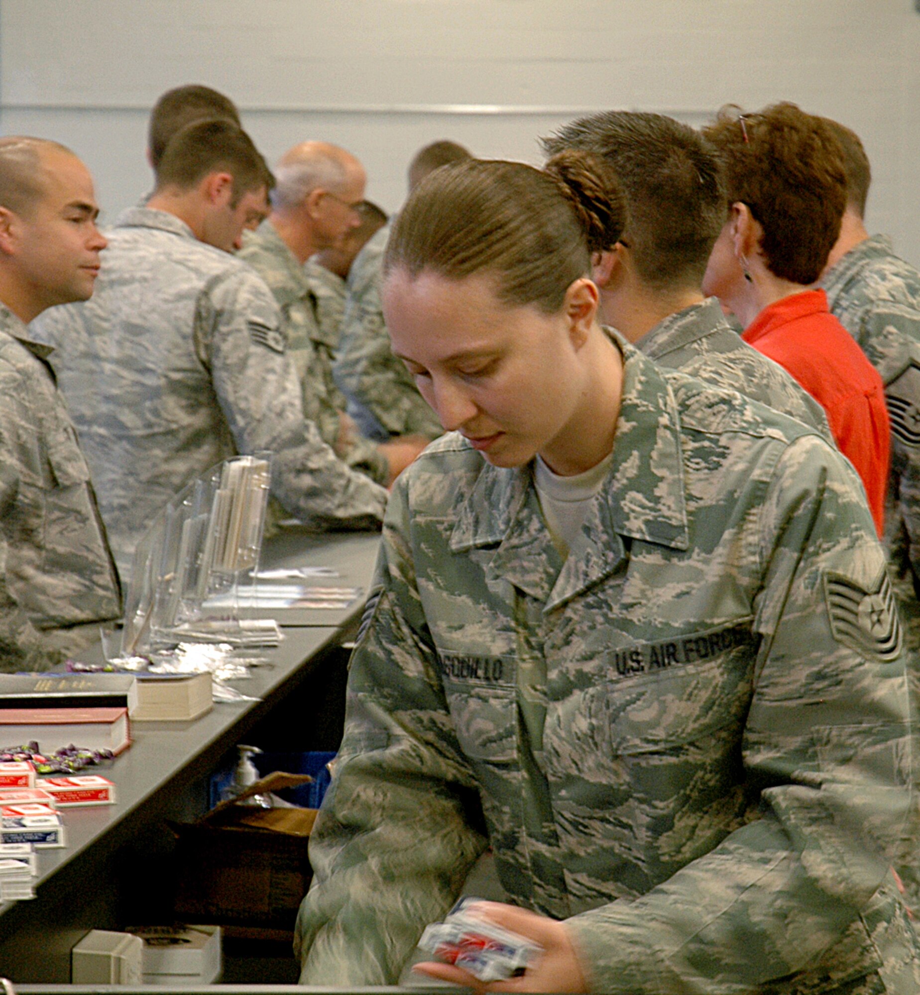 Tech. Sgt. Stephanie Carrasquillo, 446th Mission Support Group Airmen & Family Readiness Flight, Joint Base Lewis-McChord, McChord Field, Wash., gathers material to hand out to Airmen moving through the deployment processing line June 29, including 27 Reserve maintenance Airmen. (U.S. Air Force photo/Sandra Pishner)