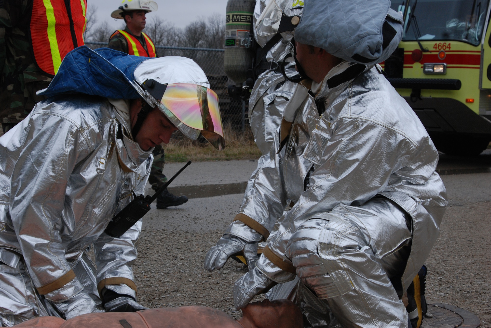 932nd Airlift Wing firefighters check the status of a "patient" they rescued during a training drill at the Air Force Reserve Command unit, located at Scott Air Force Base, Ill.  (U.S. Air Force photo/Maj. Stan Paregien)