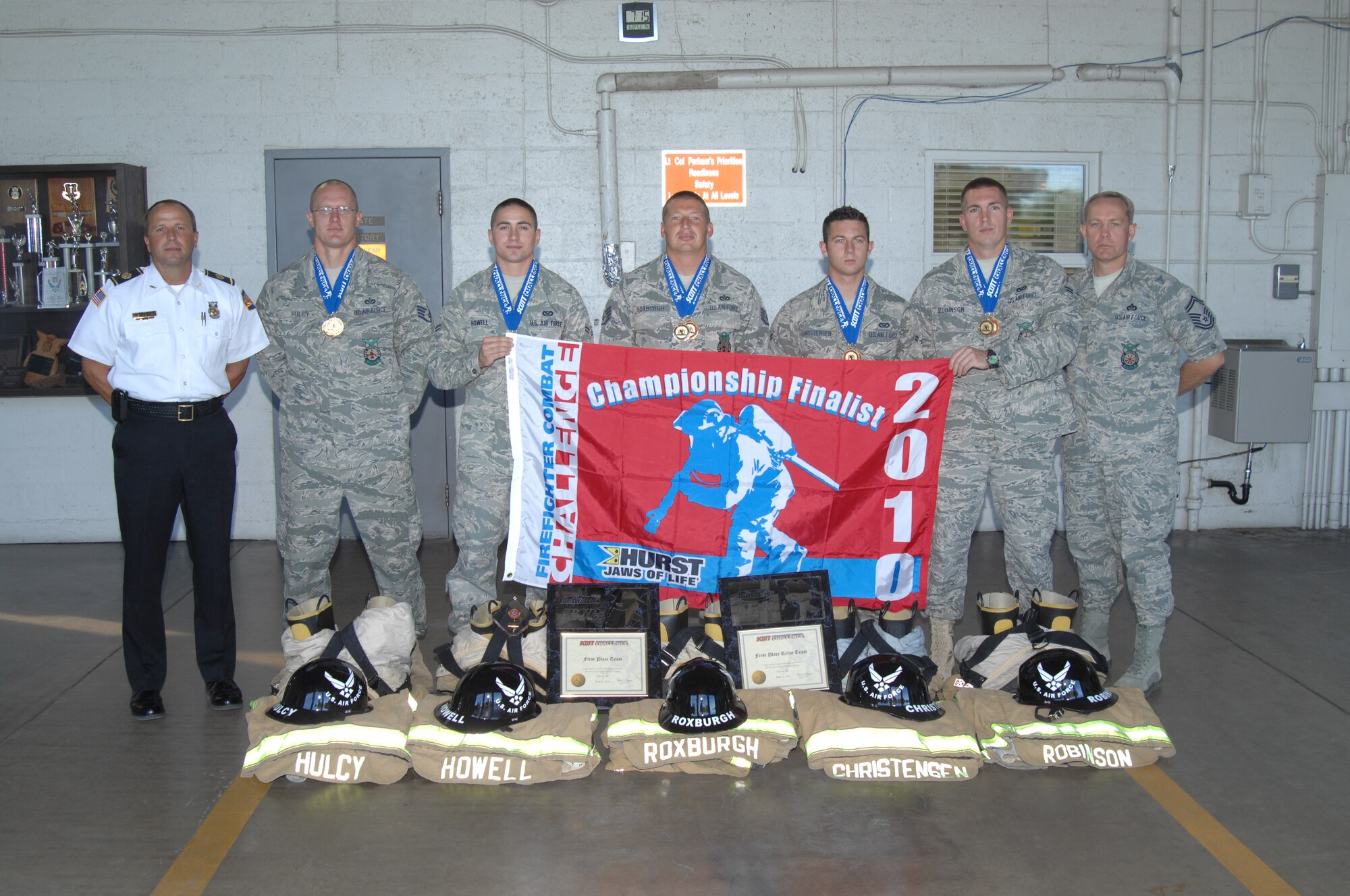 Staff Sgt. Mike Hulcy (second from left), Airman 1st Class Mike Howell, Staff Sgt. Ryan Roxburgh and Airmen 1st Class Garrett Christensen and Daniel Robinson -- all D-M firefighters -- pose for a photo with D-M Fire Chief Scott Cline (far left) and Deputy Chief Senior Master Sgt. Jim Evans at the fire station June 22, 2010. The five firefighters had just been recognized for their first-place performance at the Tucson Firefighter Combat Challenge open in early June. (U.S. Air Force photo/Staff Sgt. Jake Richmond)