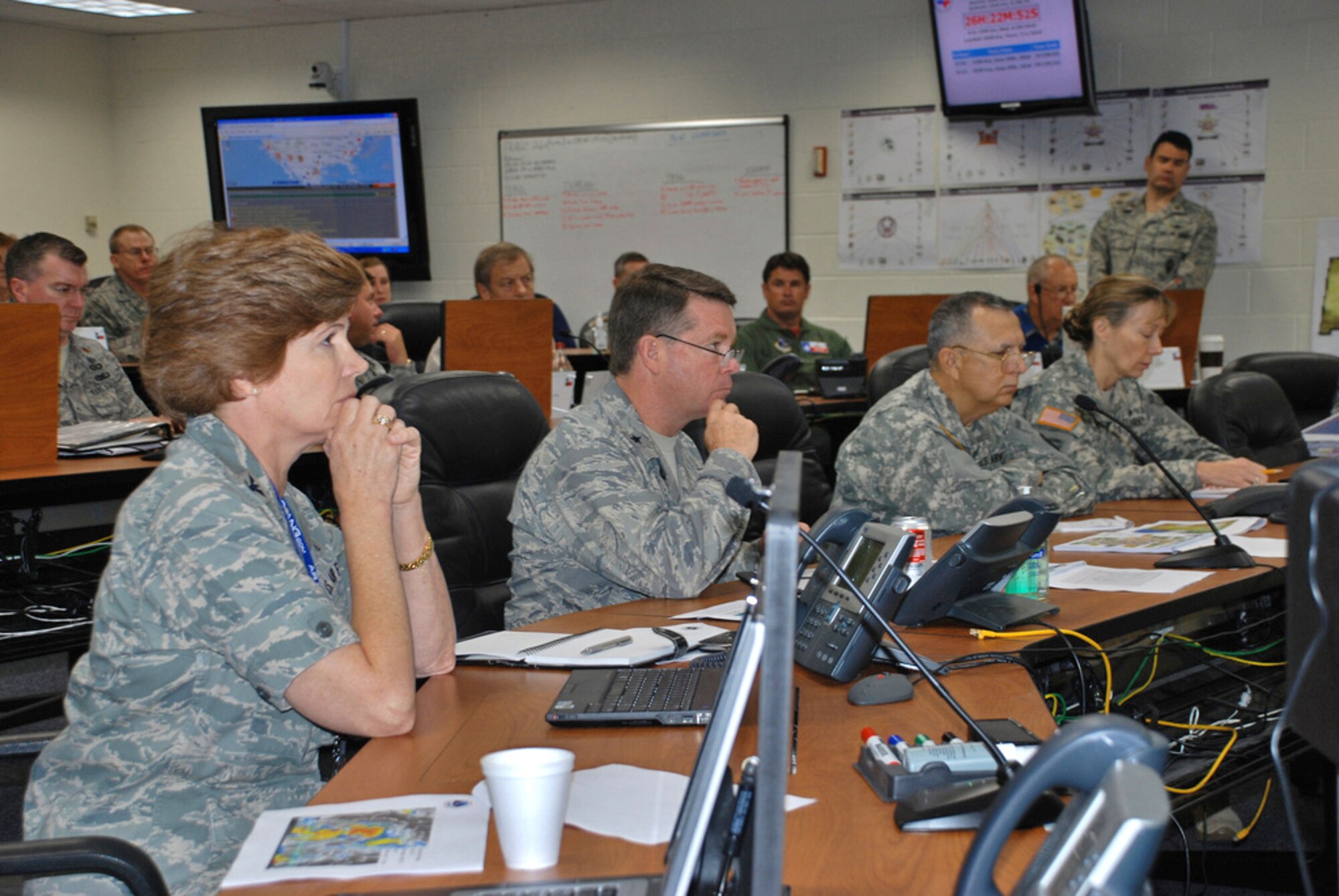 Col. Connie McNabb (left to right), Brig. Gen. John Nichols, Army Maj. Gen. Jose Mayorga and Army Brig. Gen. Joyce Stevens listen to predictions for Tropical Storm Alex in the Joint Emergency Operations Center June 29, 2010, at Camp Mabry, Texas. Colonel McNabb is the chief of the Texas Joint Staff. General Nichols is the commander of the Texas Air National Guard. General Mayorga is the Texas adjutant general. General Stevens is the commander of the Texas Army National Guard. (U.S. Army photo/Spc. Maria Moy)
 