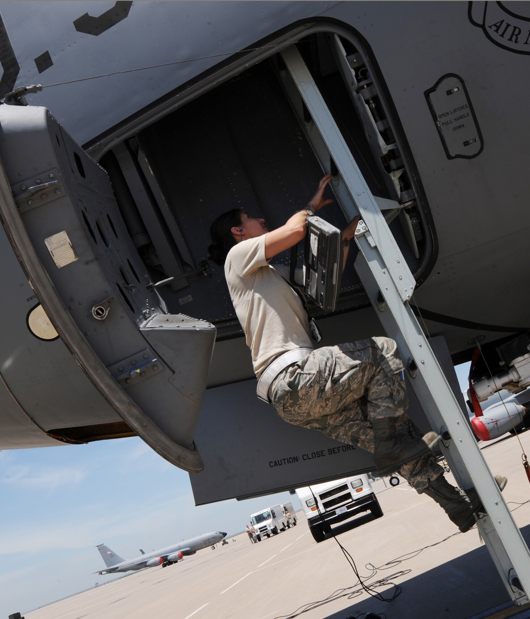 Senior Airman Christine Lea, 22nd Aircraft Maintenance Squadron instrument and flight control technician, climbs into a KC-135 Stratotanker June 3, 2010, McConnell Air Force Base, Kan.  Instrument and flight control systems Airmen inspect and repair malfunctions in avionics systems, radar, recording systems and video display systems several times a month to retain their mission-ready capability.  The diversity of the avionics systems on the KC-135 requires Airmen to be accustomed to various systems while also having the skills to maintain and repair them.  (U.S. Air Force photo/Airman 1st Class Andrea Salazar)
