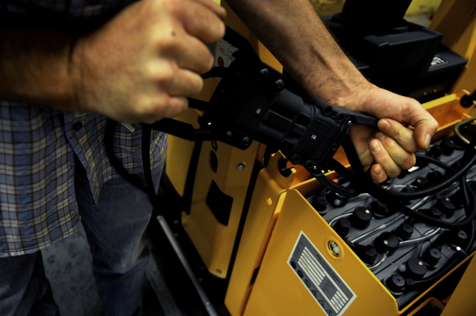 A member of the 86th Logistics Readiness Squadron material management flight charges an automated guided vehicle  June 17, 2010, at Ramstein Air Base, Germany. Members of the 86th LRS material management flight are the first to use these AGVs in the United States Air Forces in Europe Command. (U.S. Air Force photo/Airman 1st Class Grovert Fuentes-Contreras) 