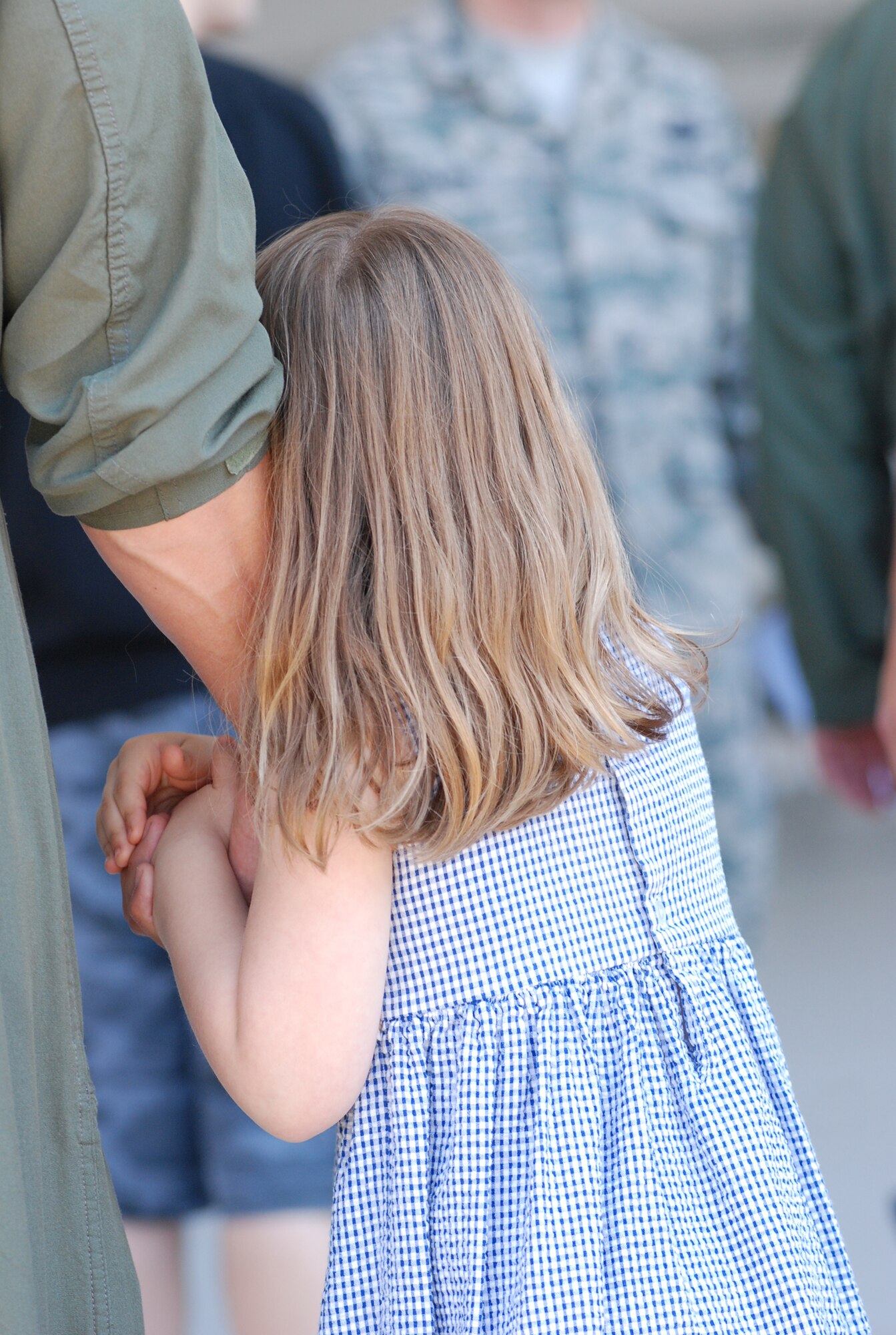 A 459th Air Refueling Wing pilot receives a warm welcome from his daughter after returning from an extended deployment to Guam here June 30. Additional KC-135R Stratotankers carrying wing servicemembers are also scheduled to return. (U.S. Air Force photo/Staff Sgt. Steve Lewis)