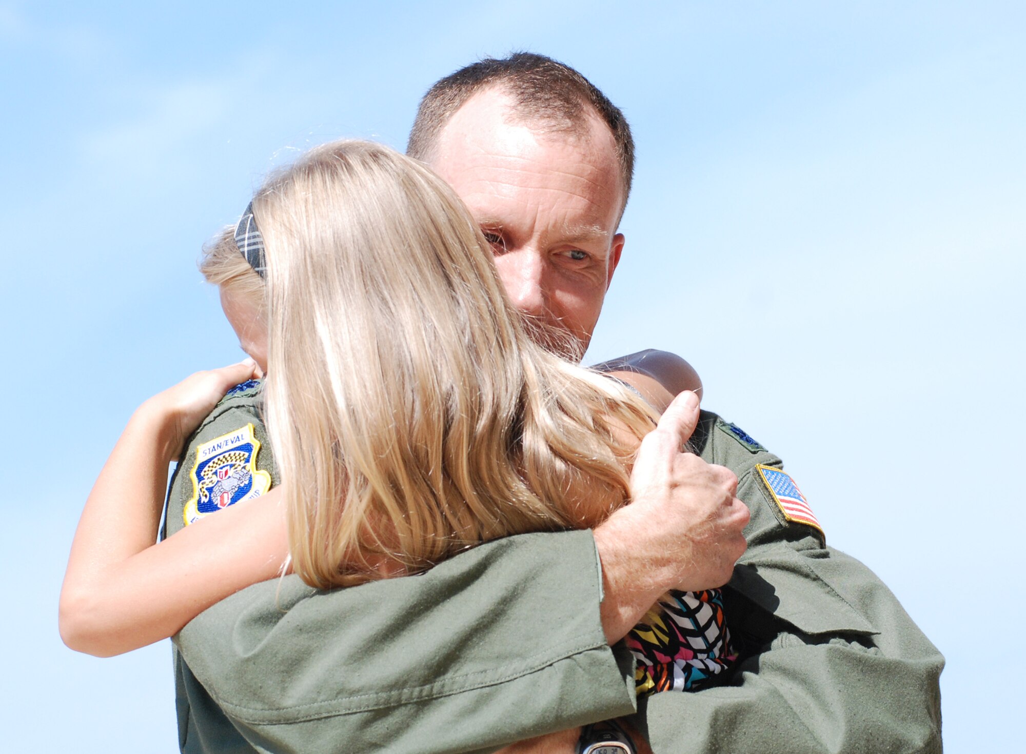 Lt. Col. Mark Deresky, 459th Air Refueling Wing, receives a warm welcome from his daughter after returning from an extended deployment to Guam here June 30. Additional KC-135R Stratotankers carrying wing servicemembers are also scheduled to return. (U.S. Air Force photo/Staff Sgt. Steve Lewis)