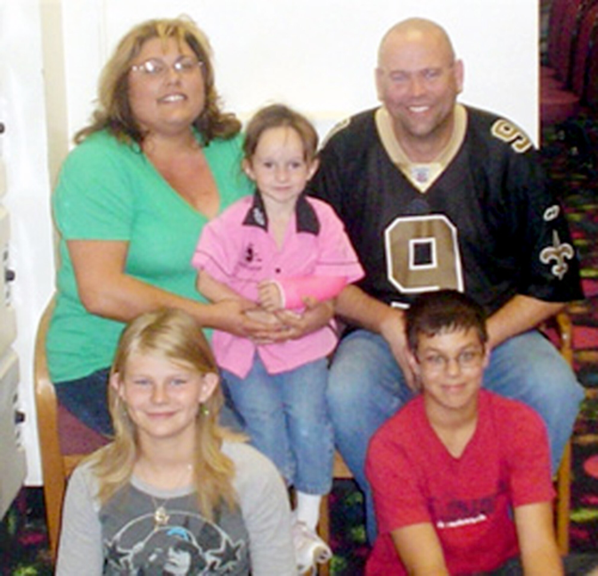 Master Sgt. Kipp M. Bourgeois and his wife, Christina, pose for a picture with their three children: Emalie, 14; Kameron, 12; and SkylarRae, 3. All three children were adopted with help from the Defense Department's adoption reimbursement program. (Courtesy photo) 

