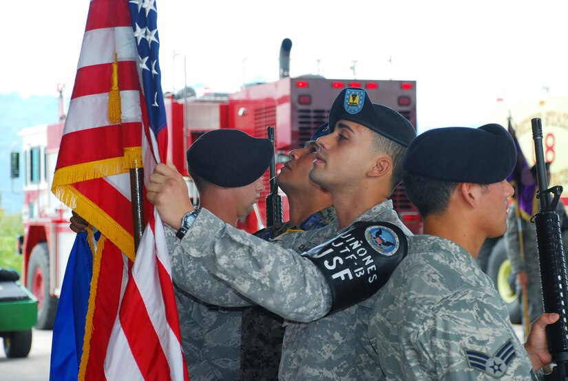 SOTO CANO AIR BASE, Republic of Honduras -- Spc. Ernie Quinones, of the Joint Security Forces here, prepares the colors for a change of command ceremony here June 29. Maj. James Meier took command from Lt. Col. Theodore Breuker at the ceremony. (U.S. Air Force photo/Martin Chahin)