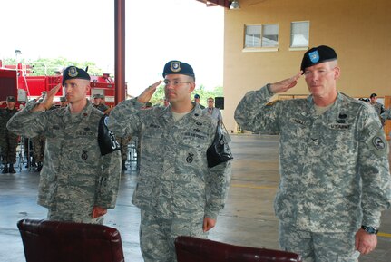SOTO CANO AIR BASE, Republic of Honduras --  (From left) Maj. James Meier, Lt. Col. Theodore Breuker and Col. Gregory Reilly, the Joint Task Force Bravo commander, salute the colors during the playing of the Honduran and U.S. national anthems during a change of command ceremony here June 29. Major Meier took command of the Joint Security Forces here from Colonel Breuker. (U.S. Air Force photo/Martin Chahin)