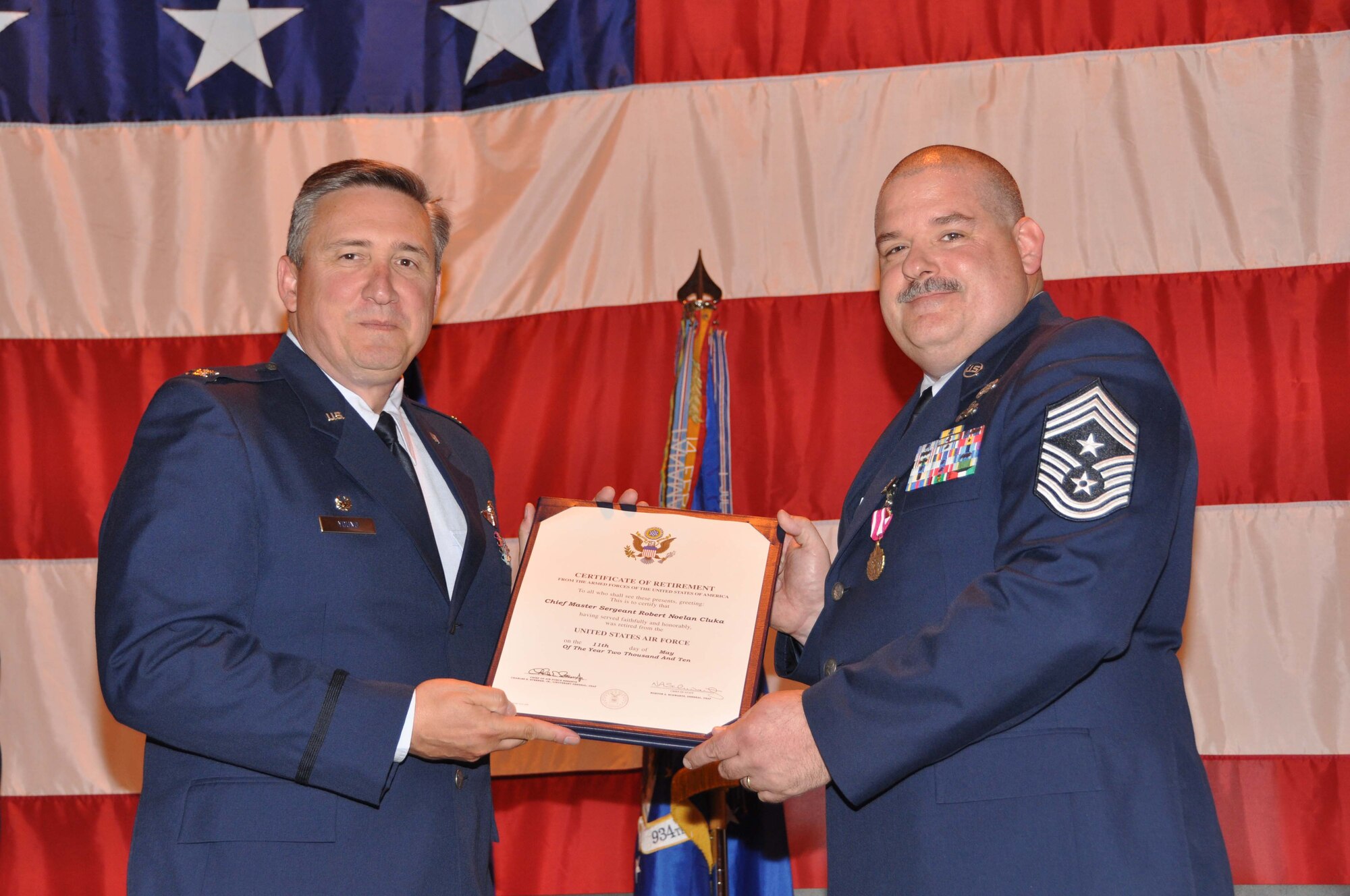 Command Chief Master Sgt. Robert Cluka is presented his retirement certificate by Col. Darrell Young, 934th Airlift Wing commander, at a ceremony June 5. (Air Force photo/Senior Airman Noah Johnson).