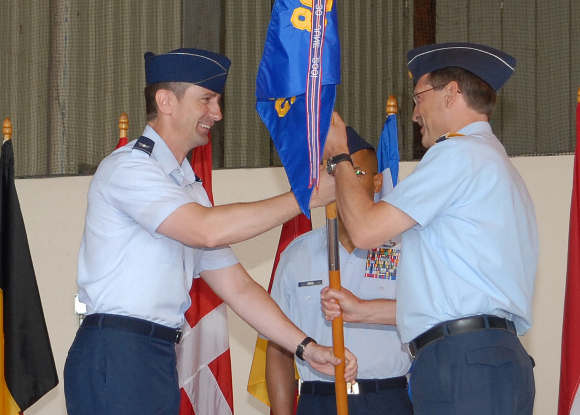 German air force Col. Eberhard von Wintzingerode-Knorr, accepts the group guidon for the 80th Operations Group from Col. Kevin Schneider, 80th Flying Training Wing commander, during a change-of-command ceremony in Hangar 2408 June 25, 2010. Colonel von Wintzingerode-Knorr returns to Sheppard Air Force Base, Texas, as a commander after graduating from the Euro-NATO Joint Jet Pilot Training Program in 1985. German air force Col. Axel Pohlmann, the outgoing commander, will become the senior international representative and chief of plans for the Combined Air Operations Center in Uedem, Germany. (U.S. Air Force Photo/Lou Anne Sledge)