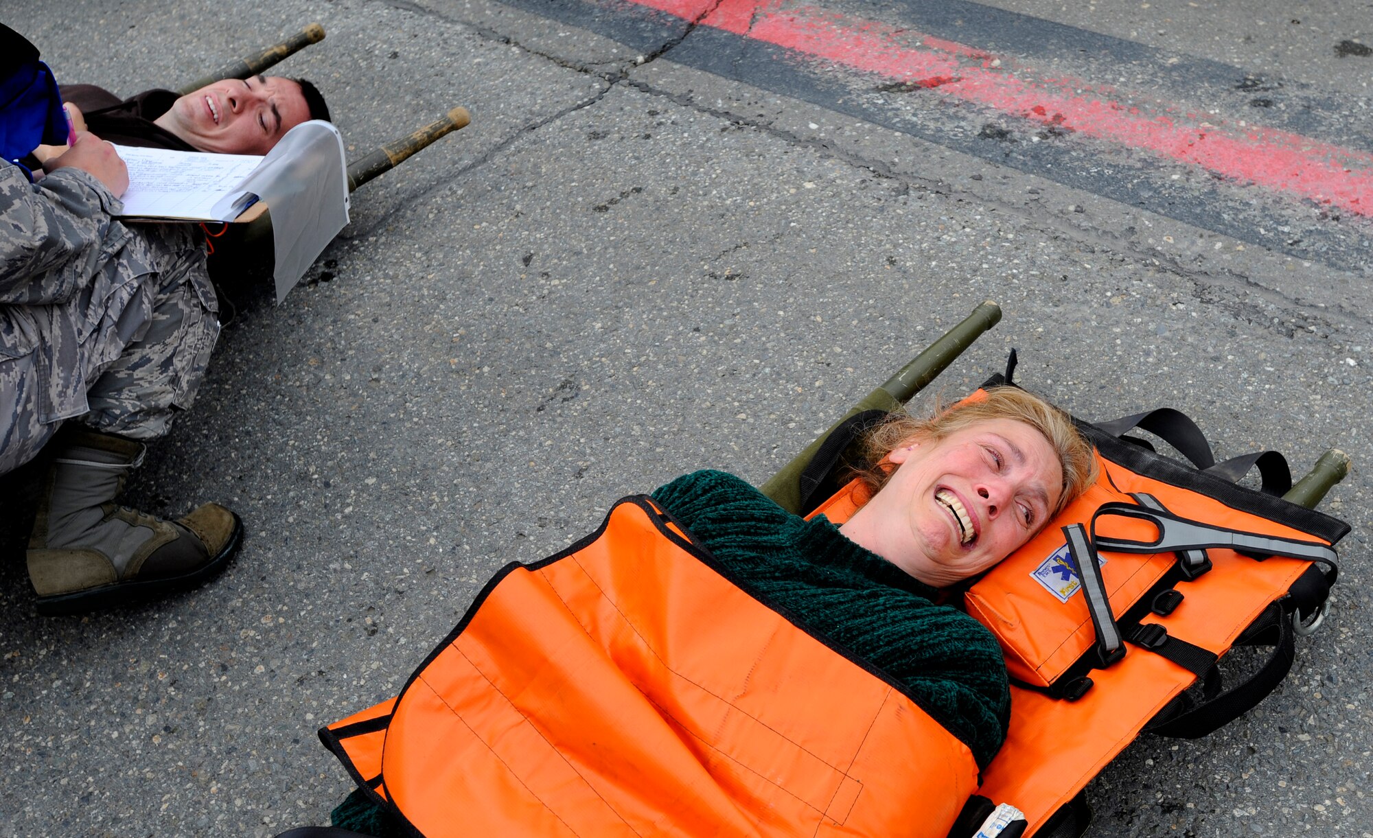 A simulated crash victim waits for care during an emergency management exercise at Joint Base Elmendorf-Richardson, June 29.  The exercise evaluated the base's ability to handle a large scale aircraft incident in preparation for the upcoming air show, Arctic Thunder 2010, July 31 and Aug. 1. (U.S. Air Force photo/Staff Sgt. Brian Ferguson)