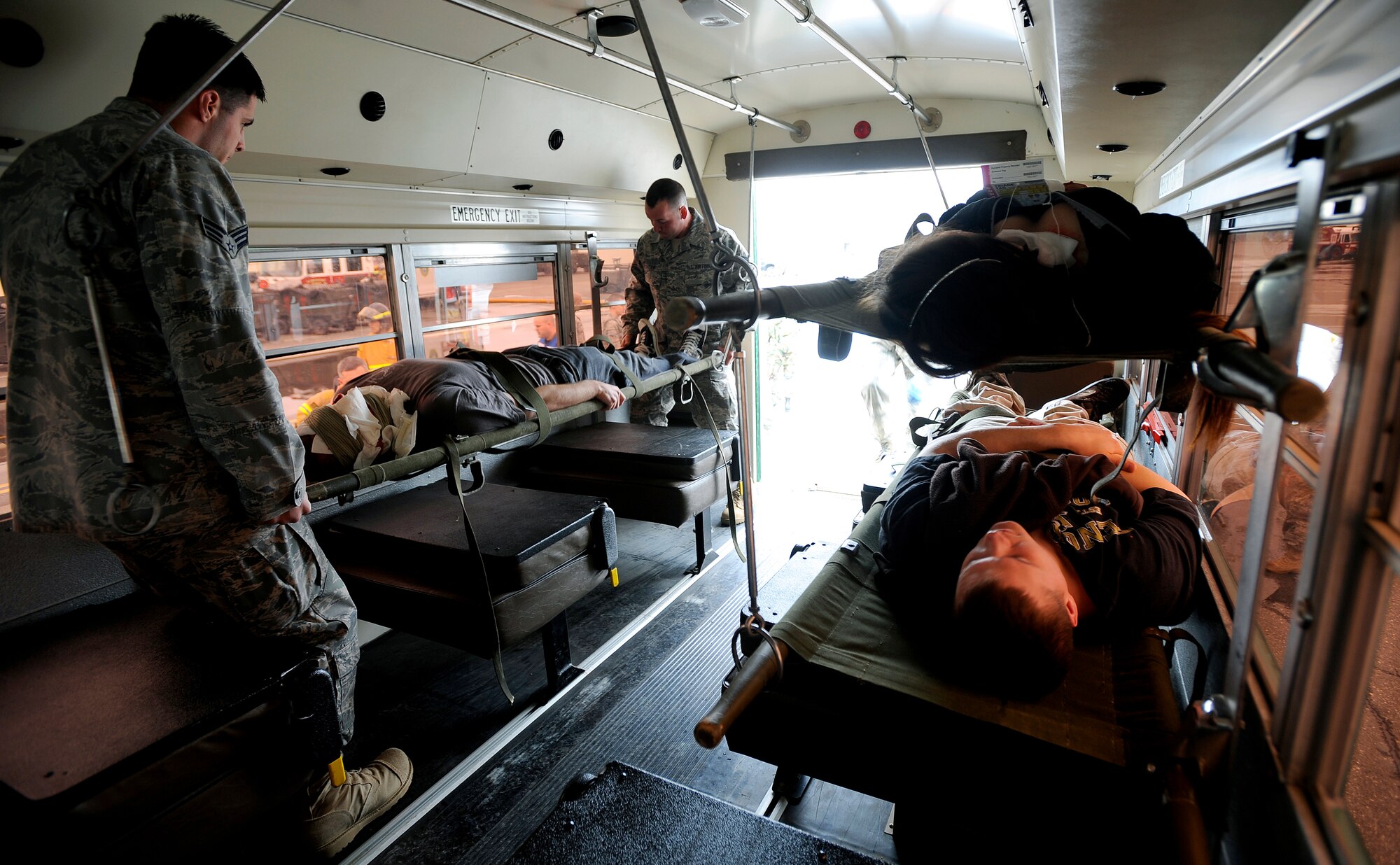 Simulated crash victims are loaded onto a bus for evacuation during an emergency management exercise at Joint Base Elmendorf-Richardson, June 29.  The exercise evaluated the base's ability to handle a large scale aircraft incident in preparation for the upcoming air show, Arctic Thunder 2010, July 31 and Aug. 1. (U.S. Air Force photo/Staff Sgt. Brian Ferguson)