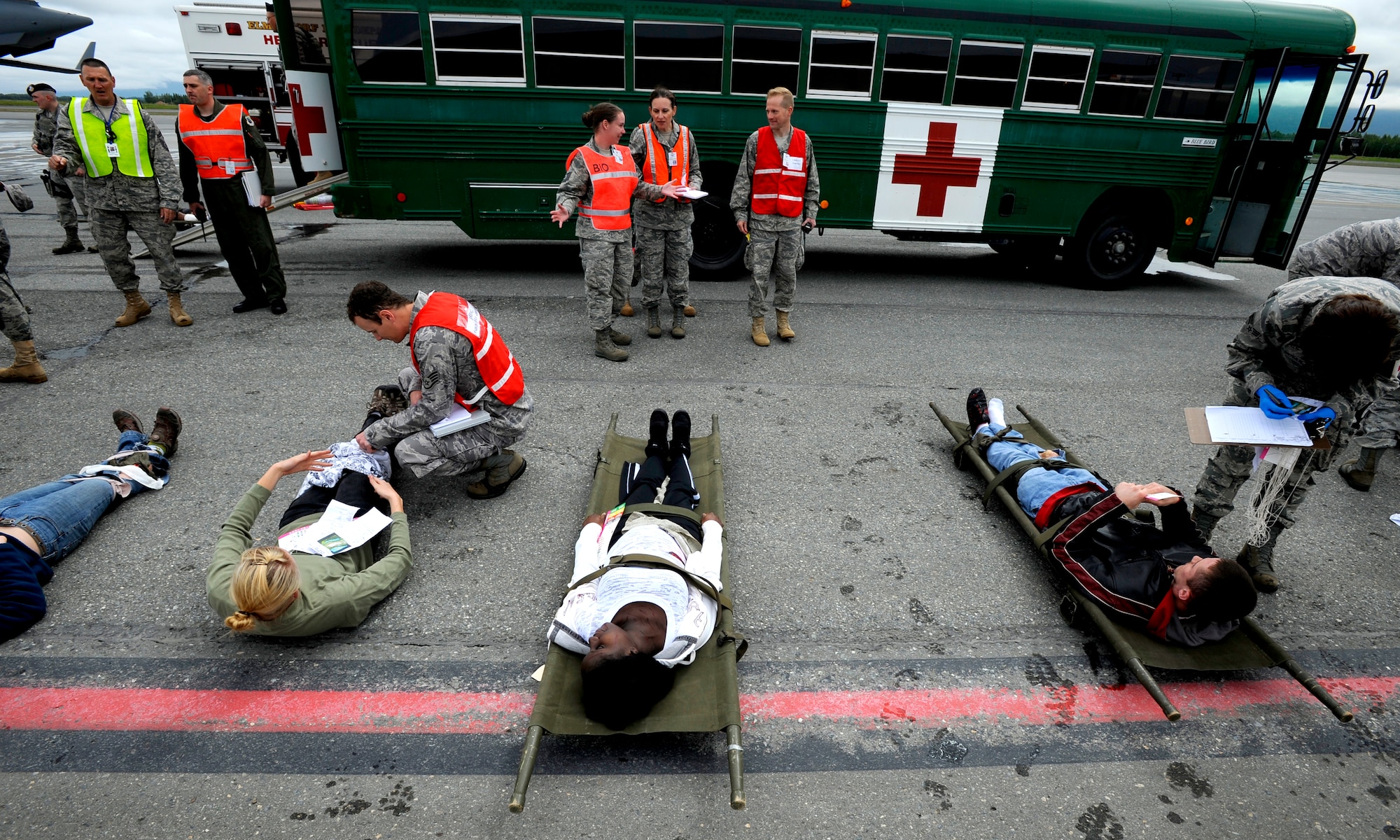 Simulated crash victims are evaluated during an emergency management exercise at Joint Base Elmendorf-Richardson, June 29.  The exercise evaluated the base's ability to handle a large scale aircraft incident in preparation for the upcoming air show, Arctic Thunder 2010, July 31 and Aug. 1. (U.S. Air Force photo/Staff Sgt. Brian Ferguson)