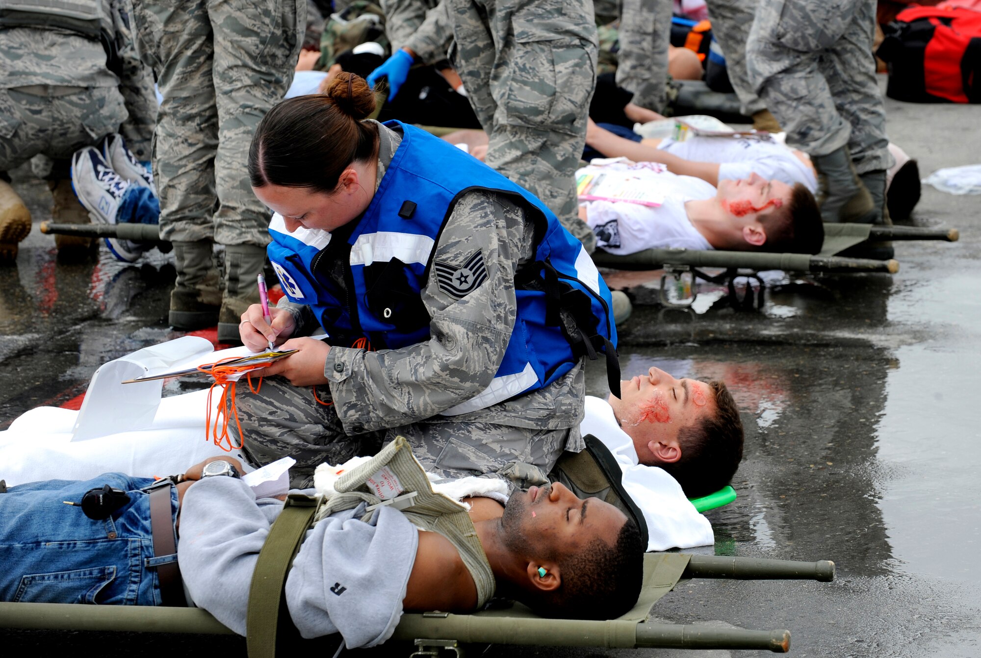A simulated crash victim is evaluated during an emergency management exercise at Joint Base Elmendorf-Richardson, June 29.  The exercise evaluated the base's ability to handle a large scale aircraft incident in preparation for the upcoming air show, Arctic Thunder 2010, July 31 and Aug. 1. (U.S. Air Force photo/Staff Sgt. Brian Ferguson)
