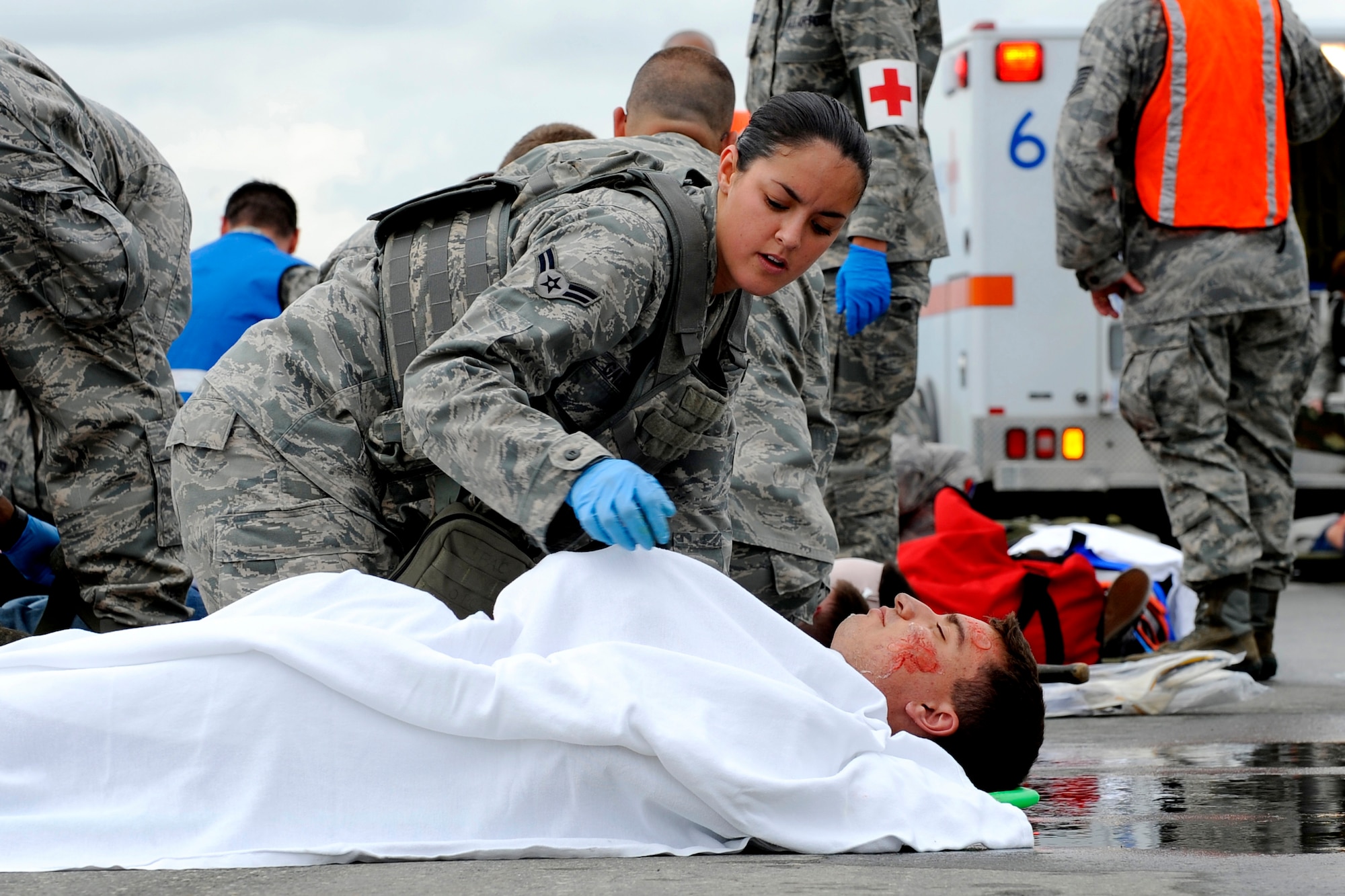 A simulated crash victim is evaluated during an emergency management exercise at Joint Base Elmendorf-Richardson, June 29.  The exercise evaluated the base's ability to handle a large scale aircraft incident in preparation for the upcoming air show, Arctic Thunder 2010, July 31 and Aug. 1. (U.S. Air Force photo/Staff Sgt. Brian Ferguson)