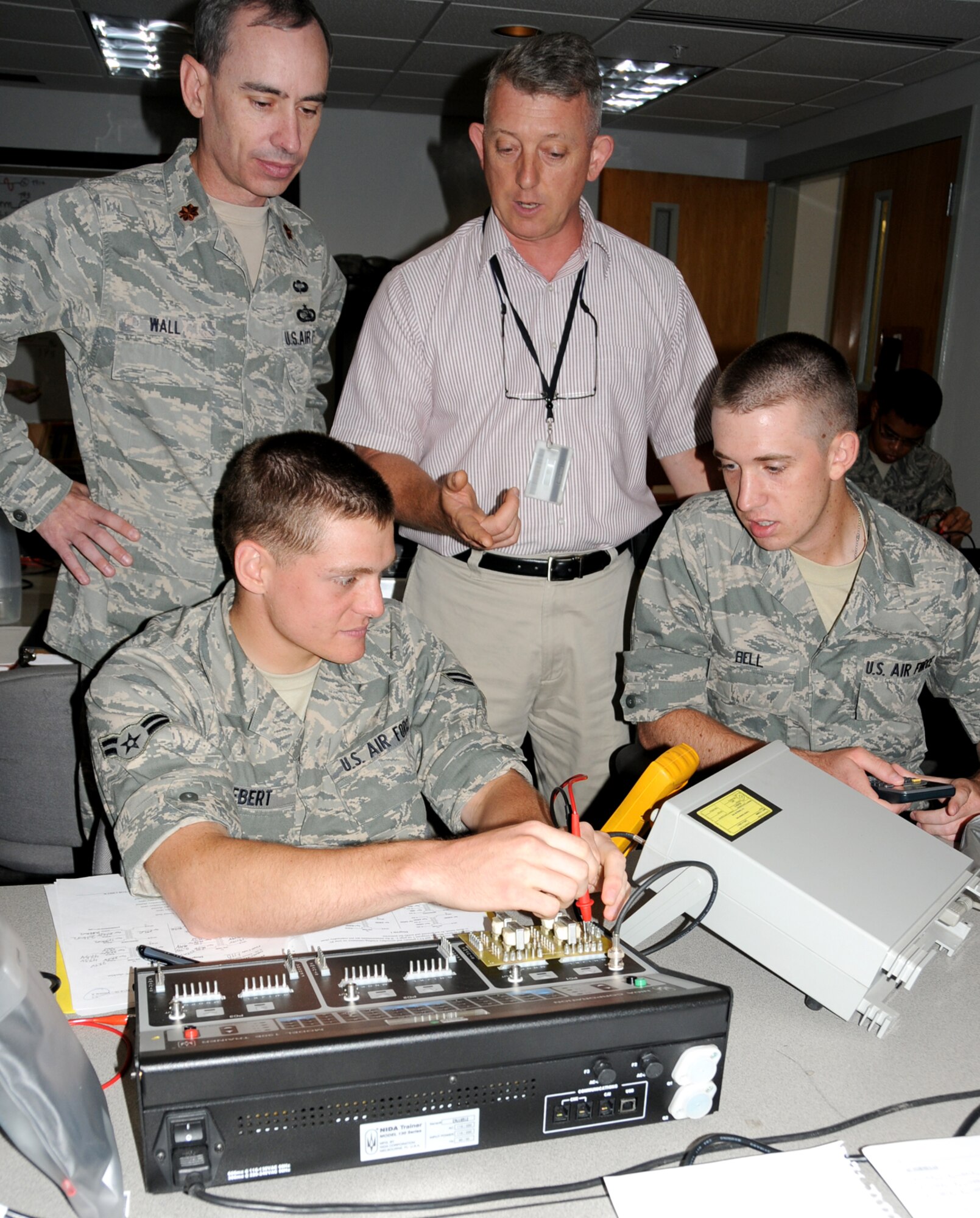 Maj. Trevor Wall, new commander of the 332nd Training Squadron, is briefed by Michael Gainey, information technology instructor supervisor, as Airman 1st Class Ben Herbert and Airman Basic Zeth Bell get familiar with equipment used in the IT fundamentals course.  Major Wall assumed command June 17 from Lt. Col. Brad Hamant, who’ll command ROTC Detachment 640 at Miami University, Ohio.  (U.S. Air Force photo by Kemberly Groue)